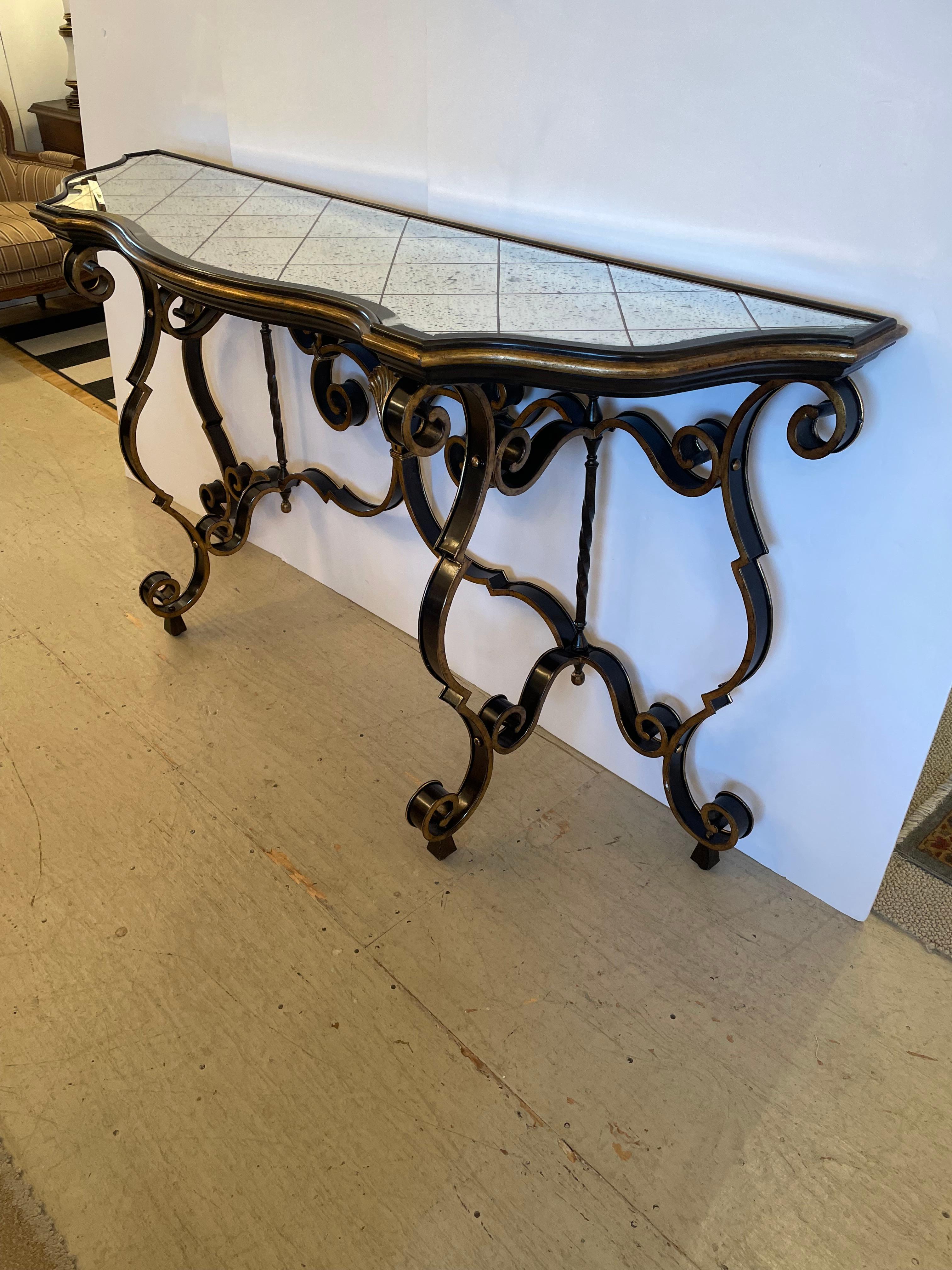 American Glamorous Large Black & Gold Hollywood Regency Iron Console with Aged Mirror Top For Sale