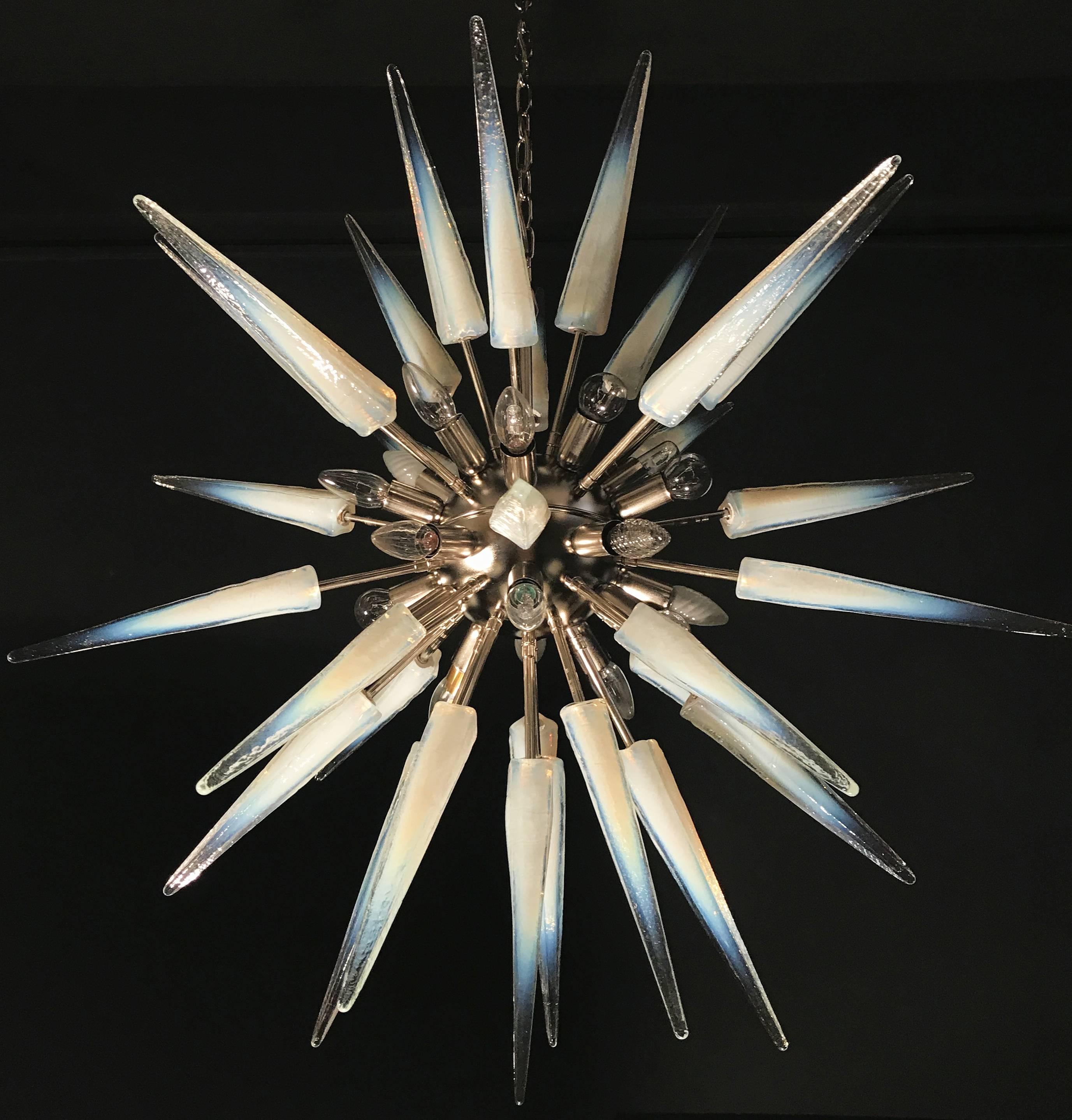 This large midcentury style chandelier with a stunning hand blown
'lattimo' opalescent Murano glass spikes. Nickel frame with 20 E 14-light bulbs.
 