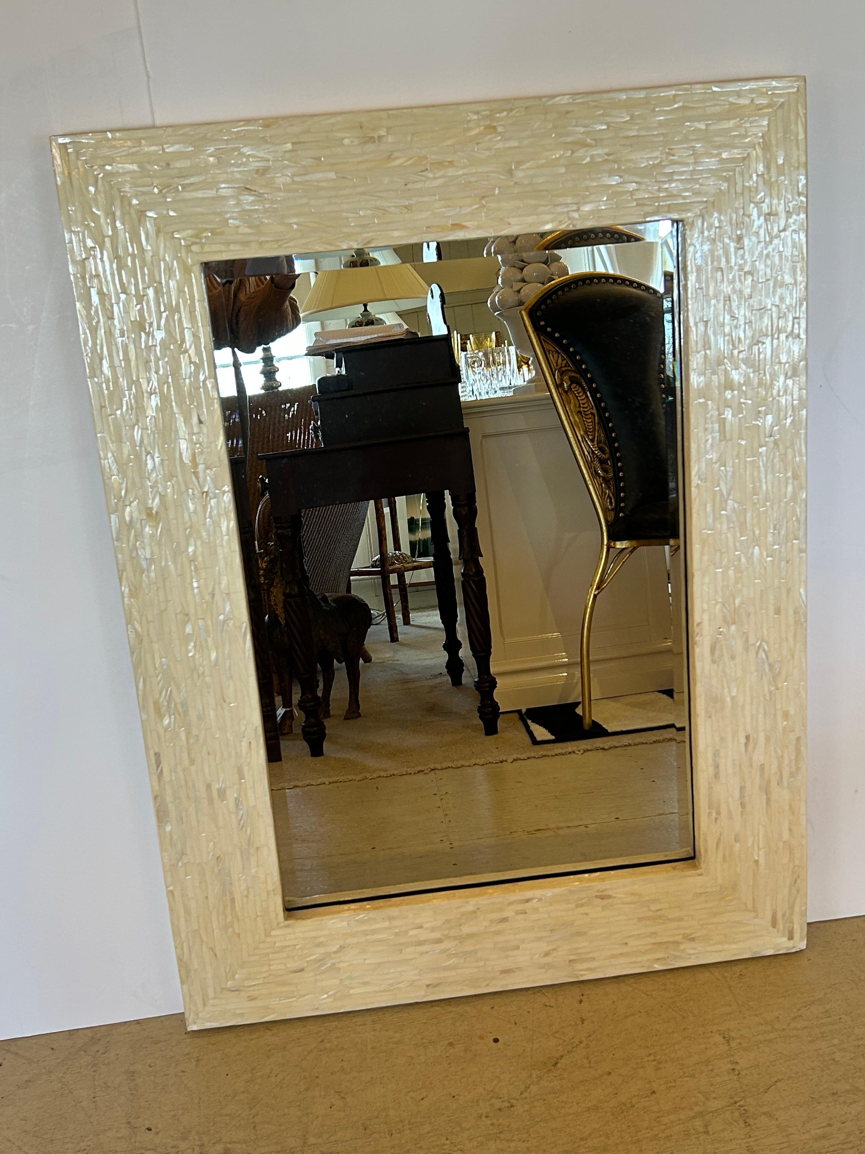 Glamorous shimmering mirror made of intricately set small rectangular pieces in a mosaic of warm white mother of pearl pieces.  Bevelled mirror itself 19.5 w 30 h