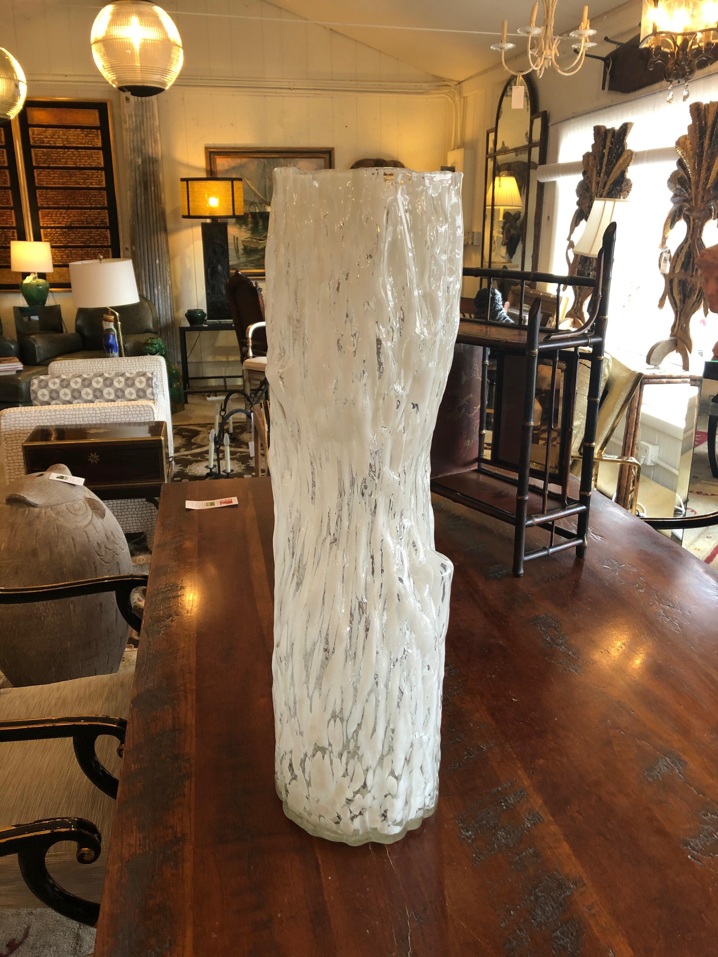 A striking very tall elongated irregularly shaped Murano vase in glamorous shimmering clear and white glass having a faux bois shape. Functional vase but sculptural art as well.