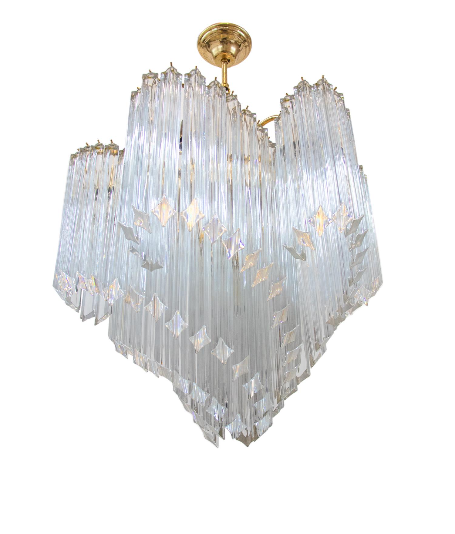 Elegant large and heavy chandelier with crystal 'Quadriedri' prisms on a spiral shaped golden metal frame. 

Measures: diameter 23.6