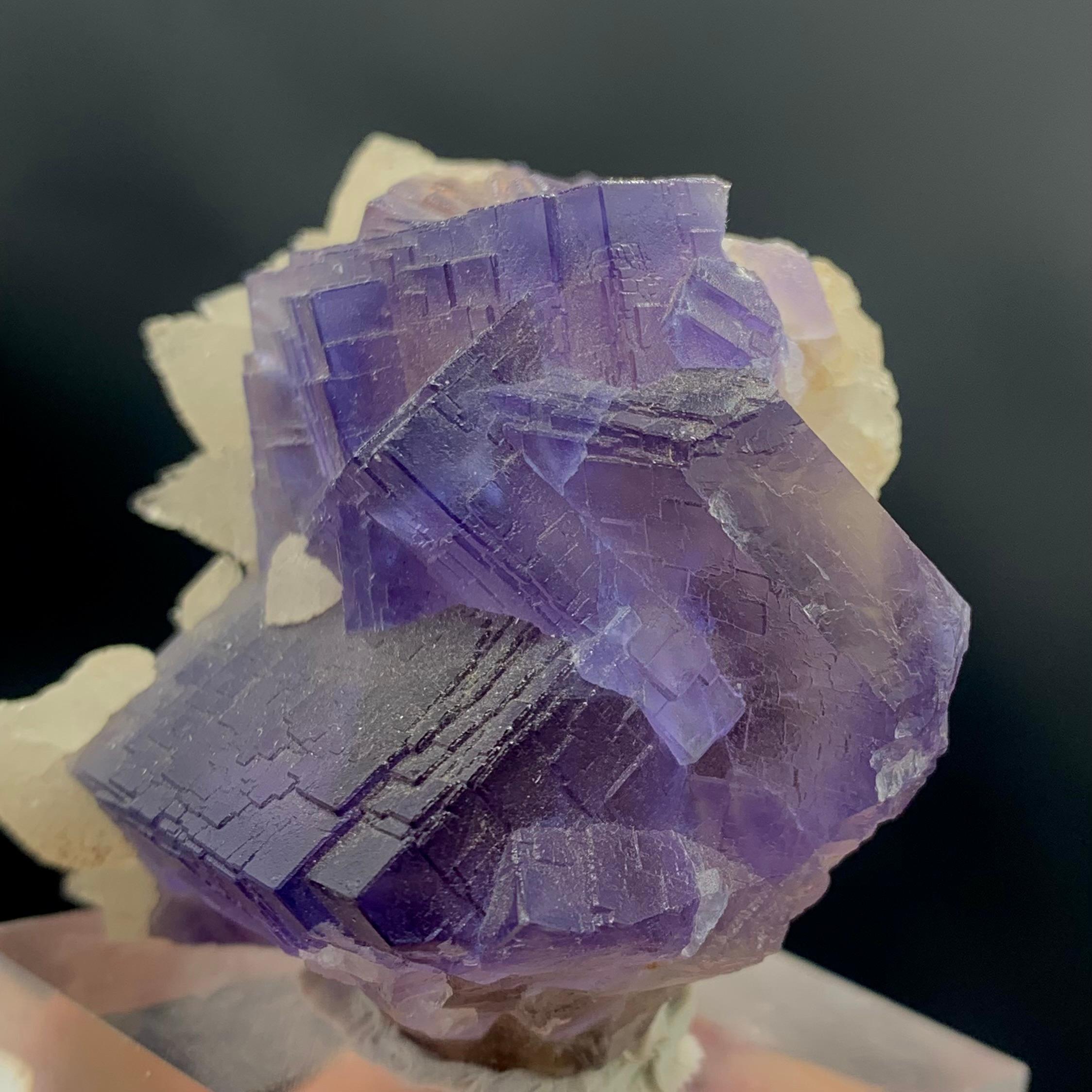 Glamorous natural purple cubic fluorite with dog tooth Calcite Specimen 
WEIGHT: 101.12 grams
DIMENSIONS: 4.5 x 4.6 x 3.2 Cm
ORIGIN : Balochistan, Pakistan
TREATMENT None

The Fluorite meaning comes from the Latin word for flux, referring to the