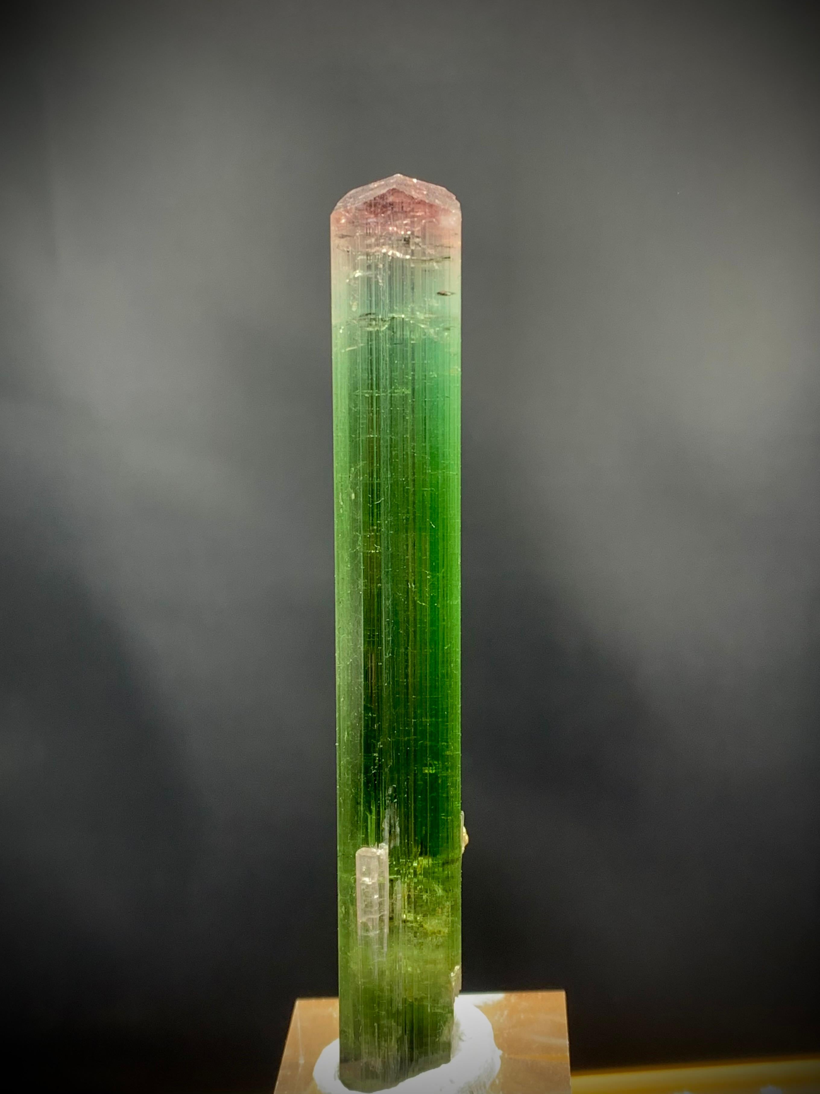 Glamorous Natural Tri Color Tourmaline crystal from Paprok Mine Afghanistan 
Weight: 26.65 grams 
Dimension: 9.0x 1.3x 1.0 Cm
Origin: Paprok mine Afghanistan
Color: Pink, Mint Green and Dark Green 
Shape: Crystal
Quality: AAA
Tourmaline is