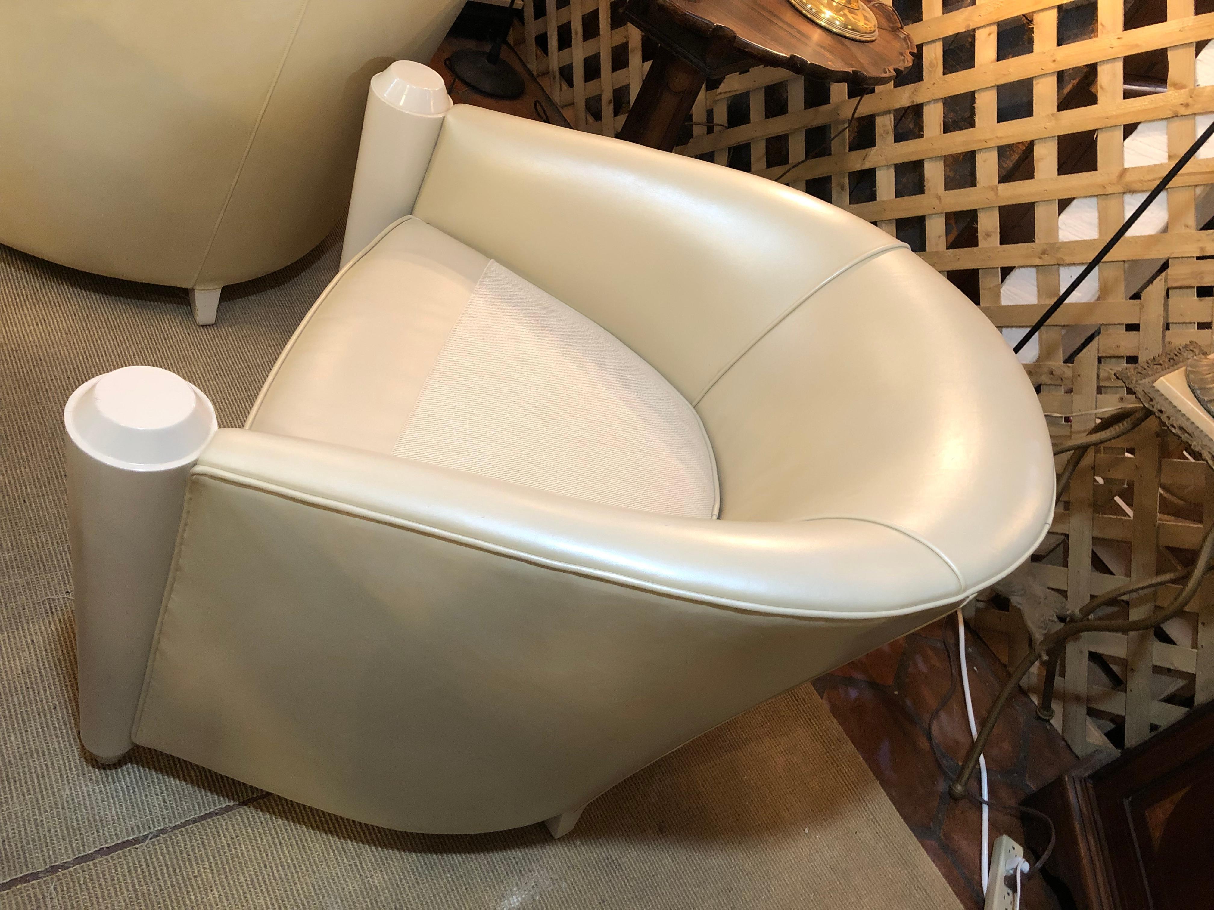 Glamorous & luxurious custom made cream leather barrel shaped club chairs having fascinating shiny cream laquer cone shaped decoration at the front of each arm and reversible seat cushions.  Local NJ craftsman, full leather hides, not pressed