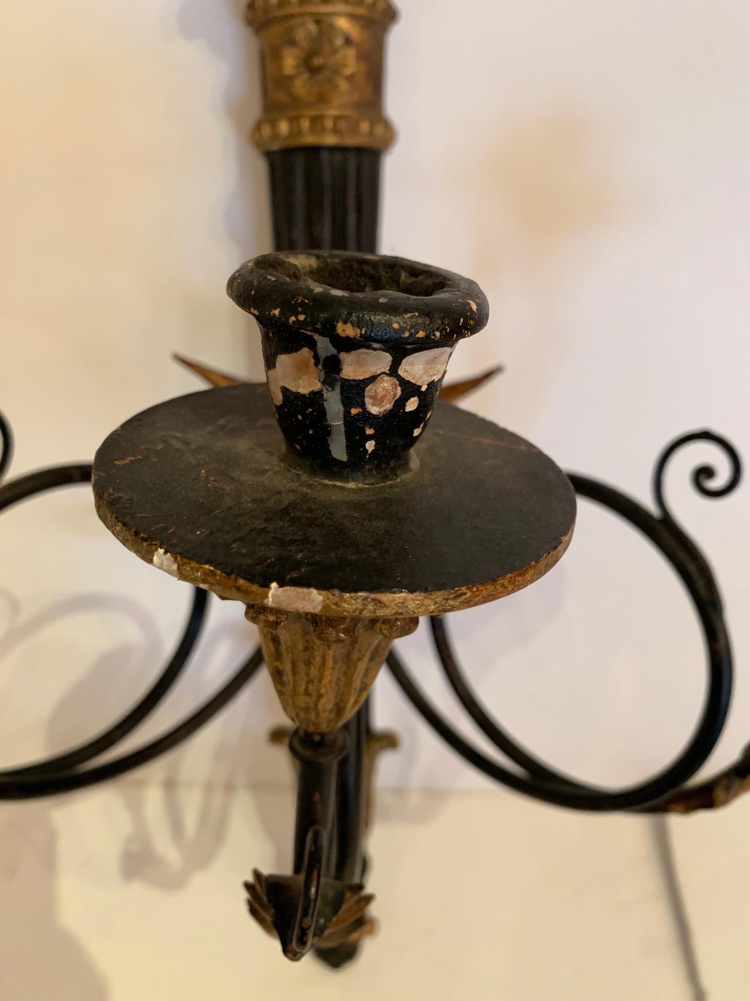 Beautiful pair of carved ebonized wood sconces having neoclassical style gilded decoration.
Note: A slightly different set of sconces is also listed to make a set of 4.