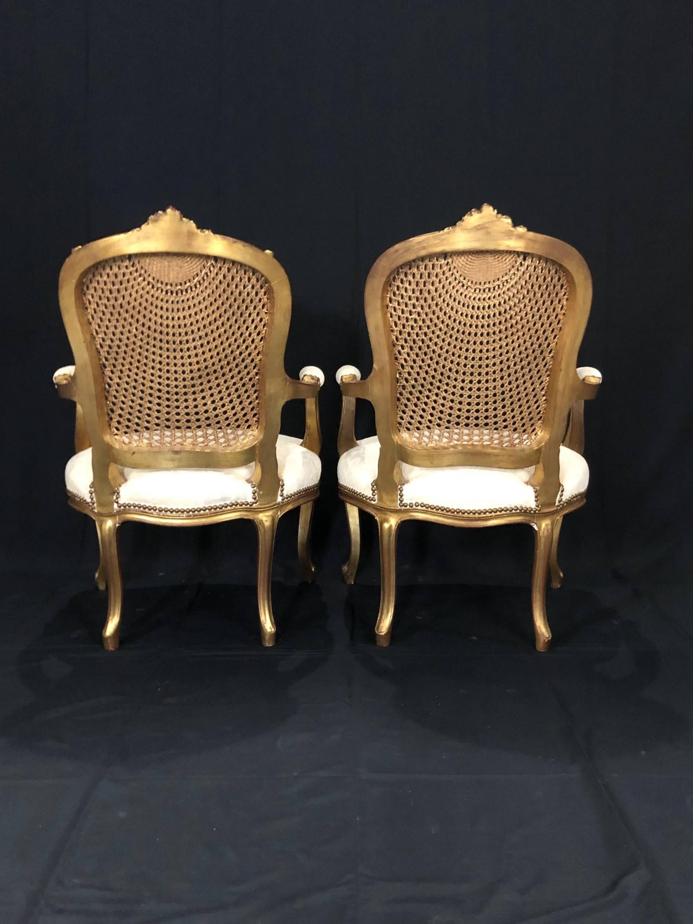 Fancy pair of French Louis XV style gilt and sunburst caned panel bergère armchairs with ivory seat cushions. 
#5064.

  