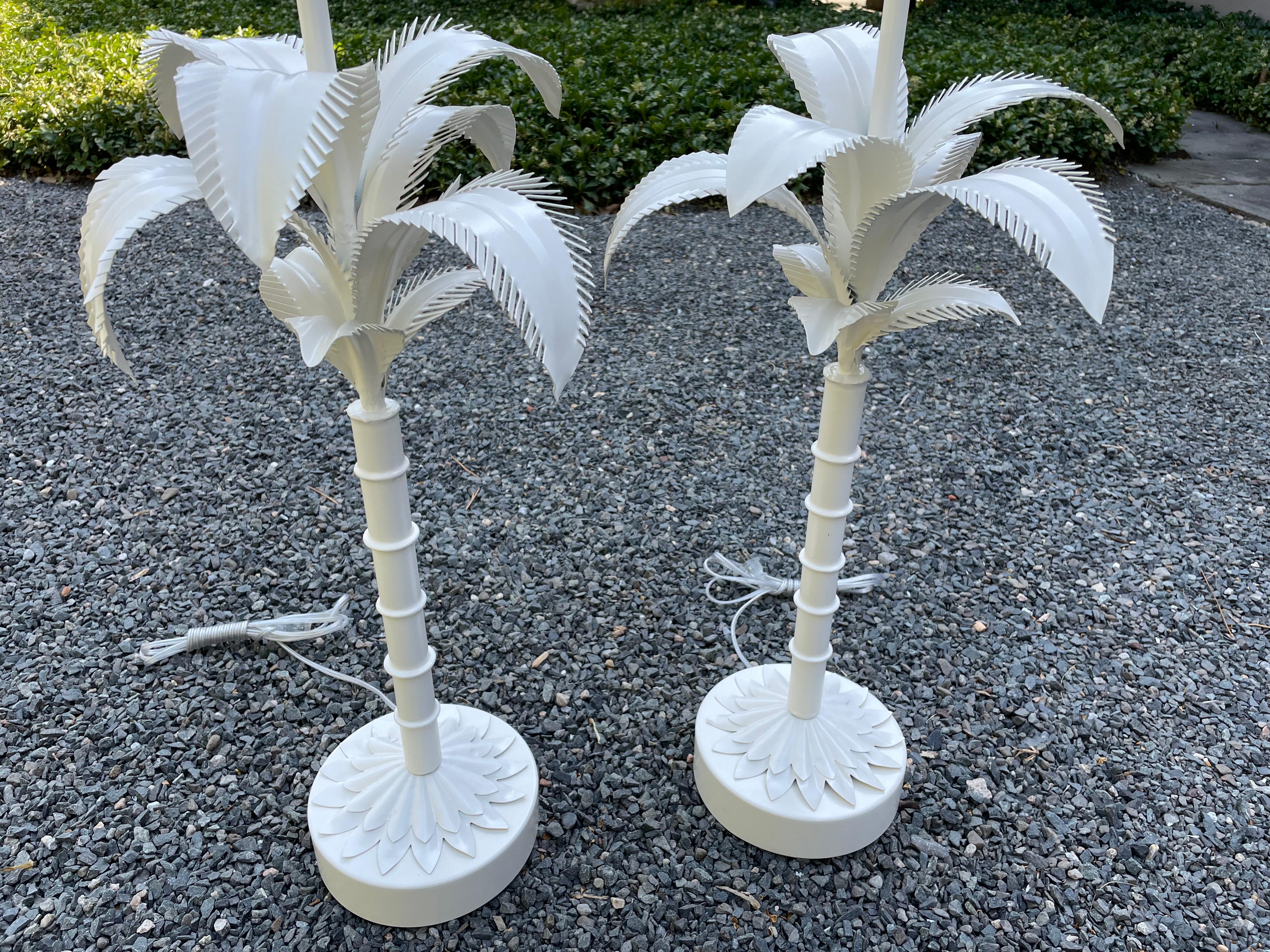 Glam pair of off white tole metal palm tree motif table lamps restored to their original appearance. Powder coated, rewired and new harps and finials, but no shades.