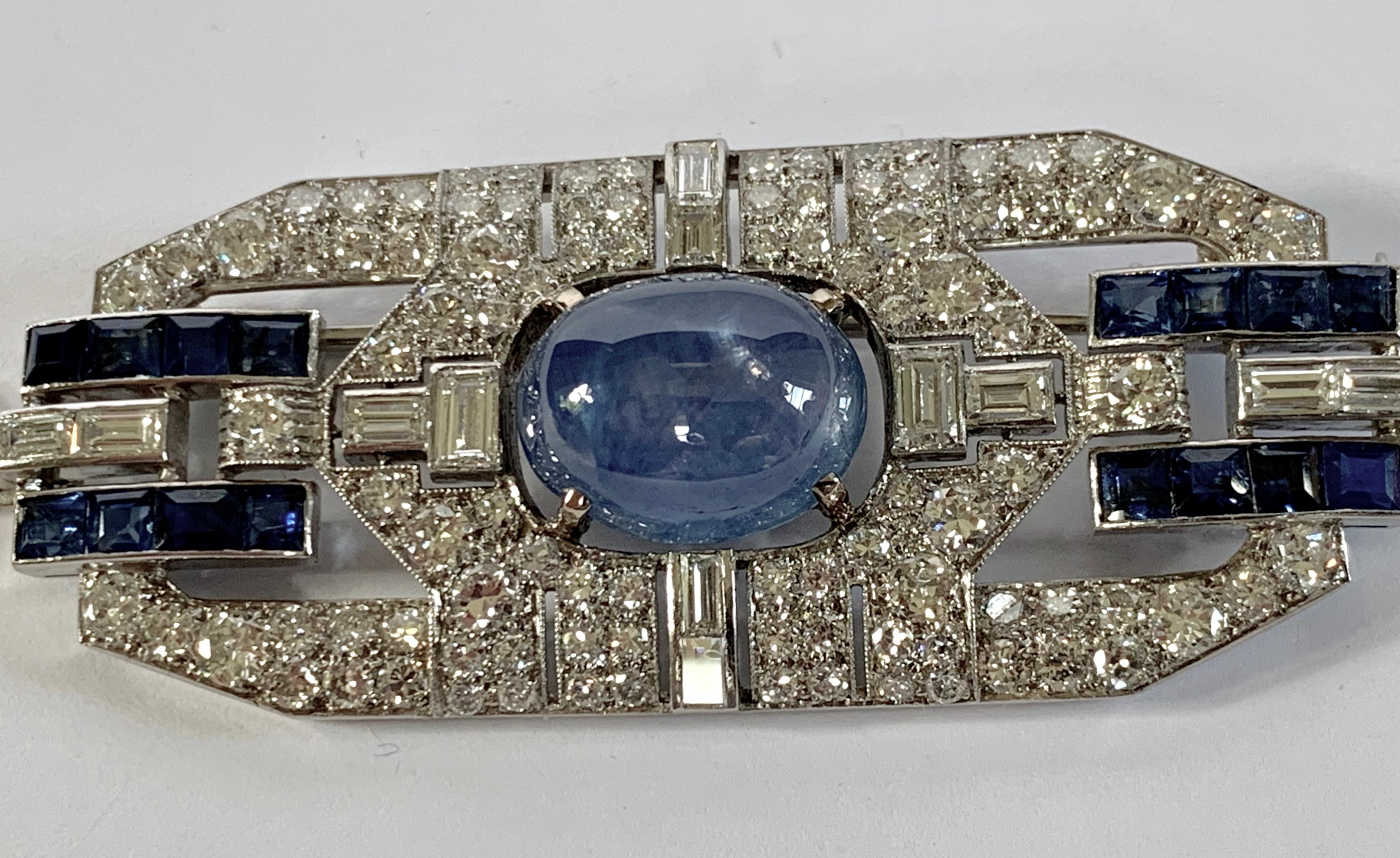The platinum openworkArt Déco plaque brooch is set with numbers diamonds, the centre is embellished with a natural Cabochon Star Sapphire. Around 1920 Length: 6.3 cm. Width: 2.7 cm. 
