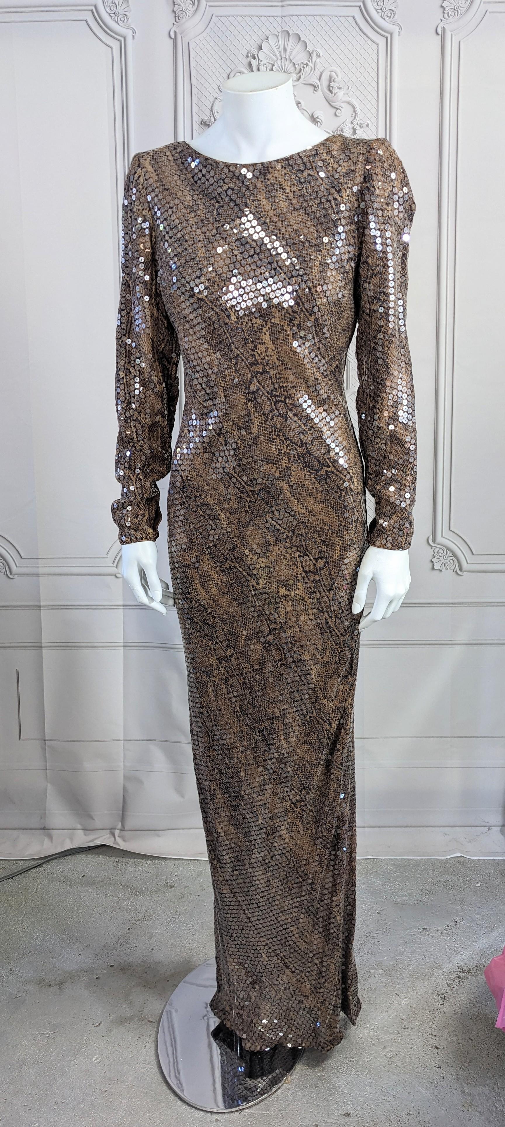Glamorous Sequin Snake Print Column Gown cut on the bias covered in clear sequins for a more subtle sheen. Slim body con cut with long sleeves and deep scoop neck with ties on back. A designer quality gown which has had label removed. 
Content shows