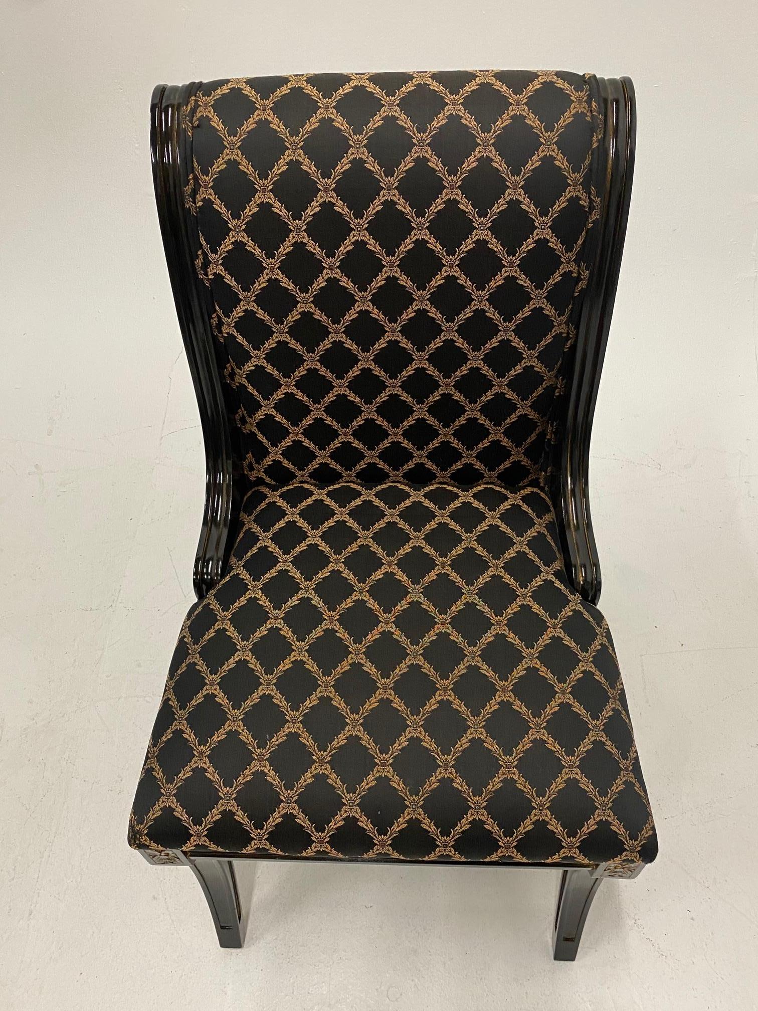A glam set of 4 side dining chairs having Hollywood Regency flair with black and gold frames and sophisticated coordinating black and gold lattice inspired upholstery.