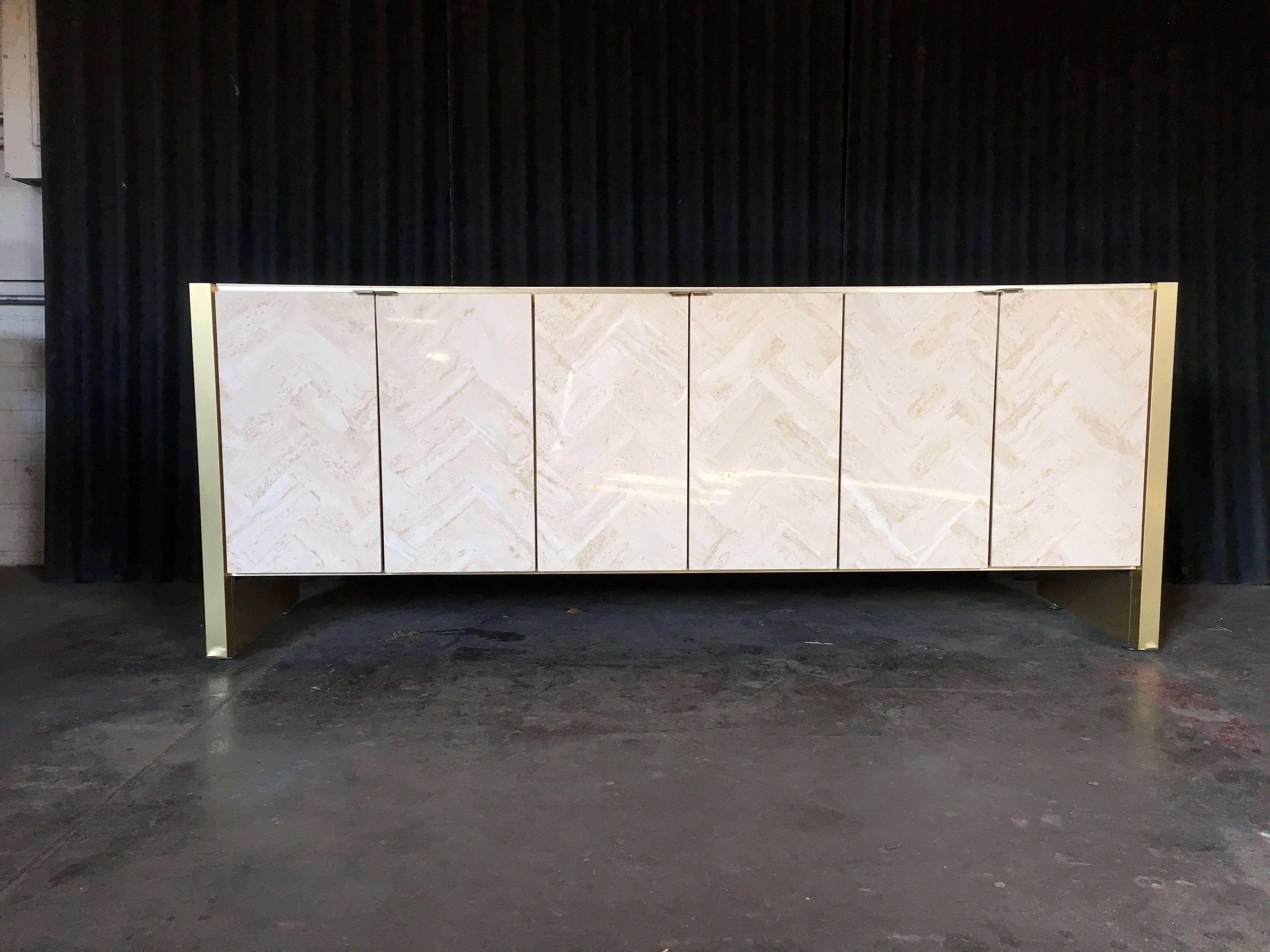 Ello or, Ello style, mid-1980s credenza with chevron pattern front and top.
Trimmed in brass plating with the handles being brass.
Comes with original shelves and drawers that function perfectly.
Drawers have been scrubbed but do have older