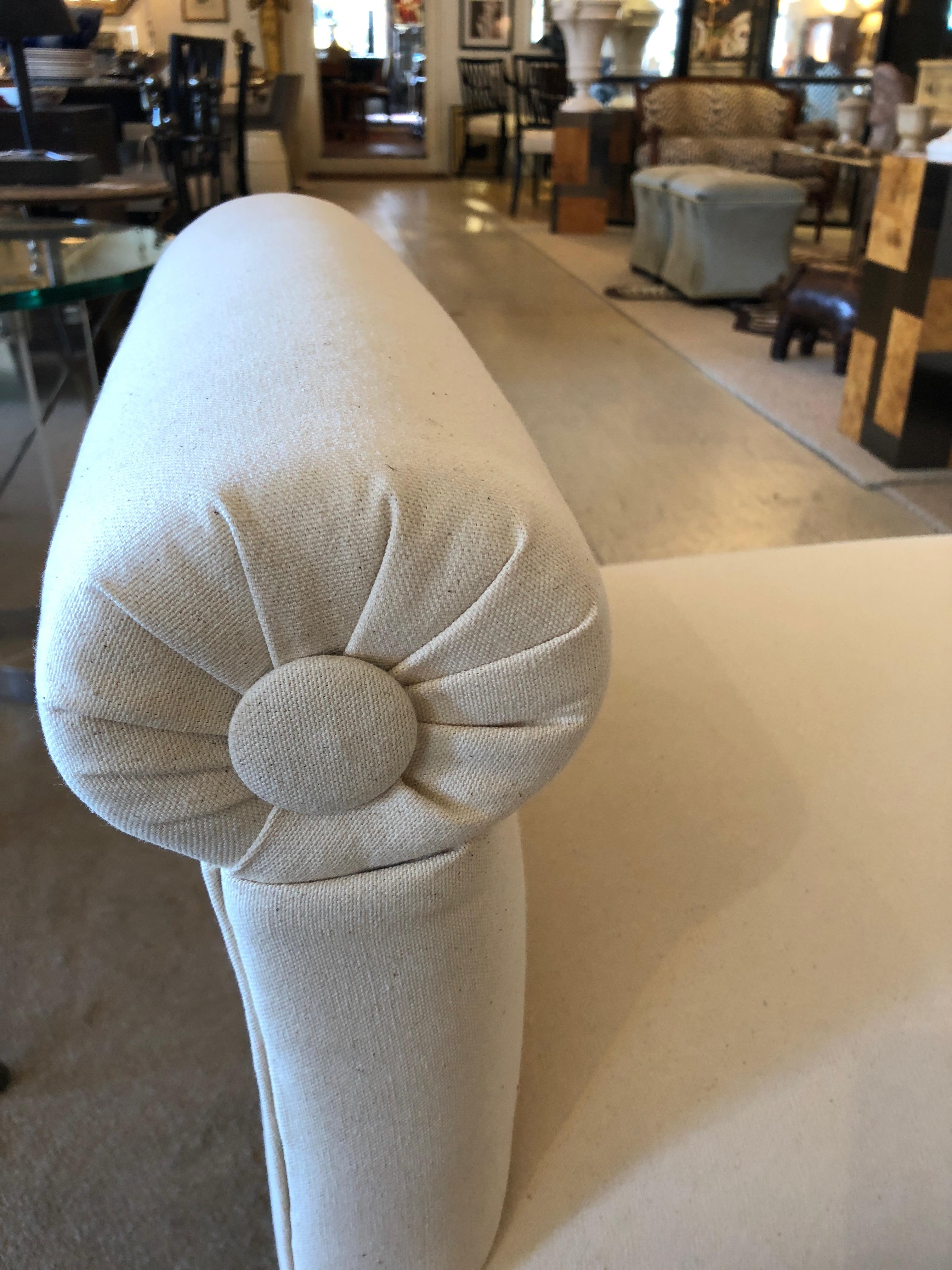 Absolutely gorgeous 1940s French newly upholstered window bench having white cotton duck fabric and gray carved wood reeded sabre legs. Great in a front hall, at the end of a bed, or in an elegant living room for extra seating.