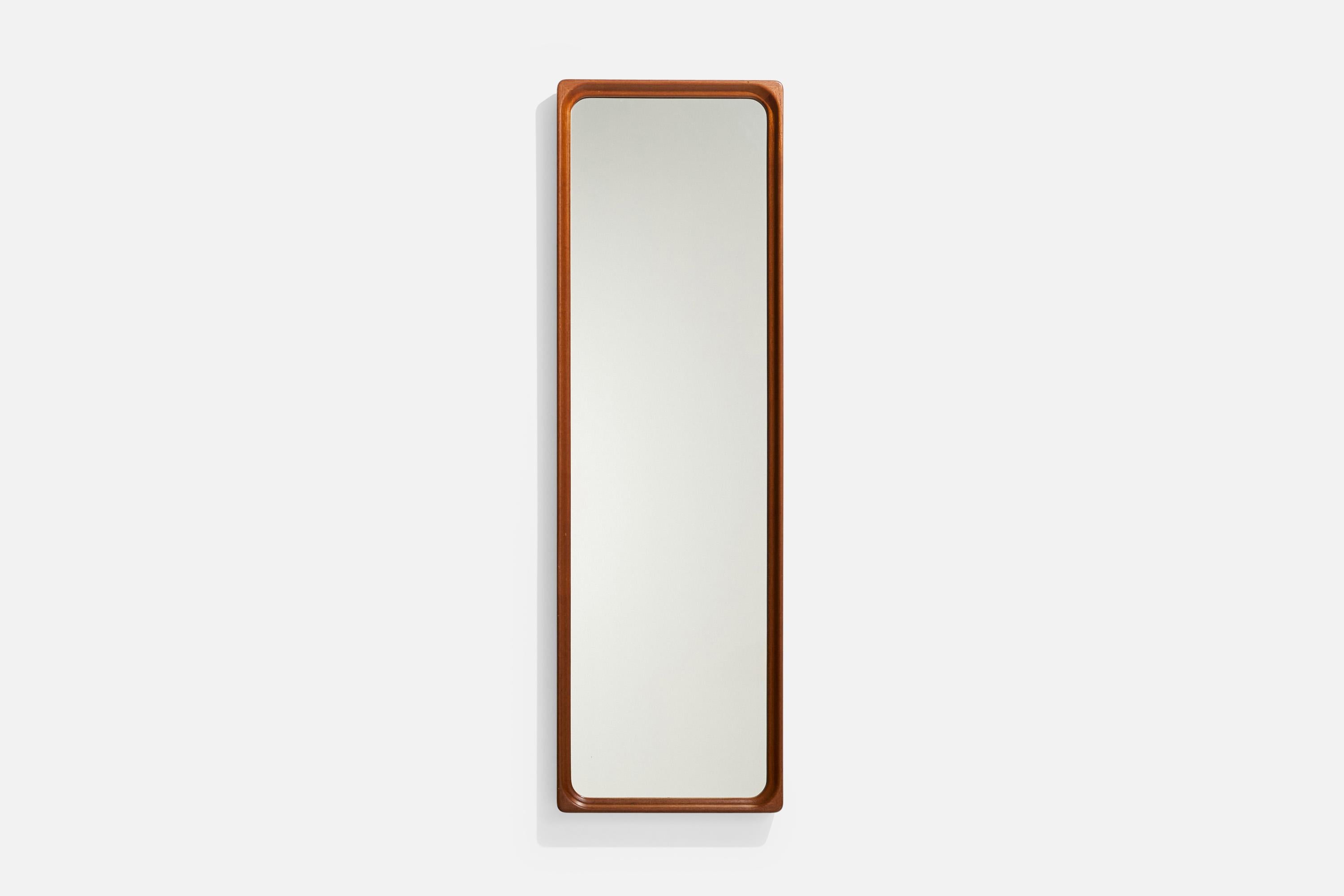 A teak wall mirror produced by Glas-Mäster, Sweden, c. 1950s.

Dimensions: 48.5” H x 15.125” W x 1.75” D