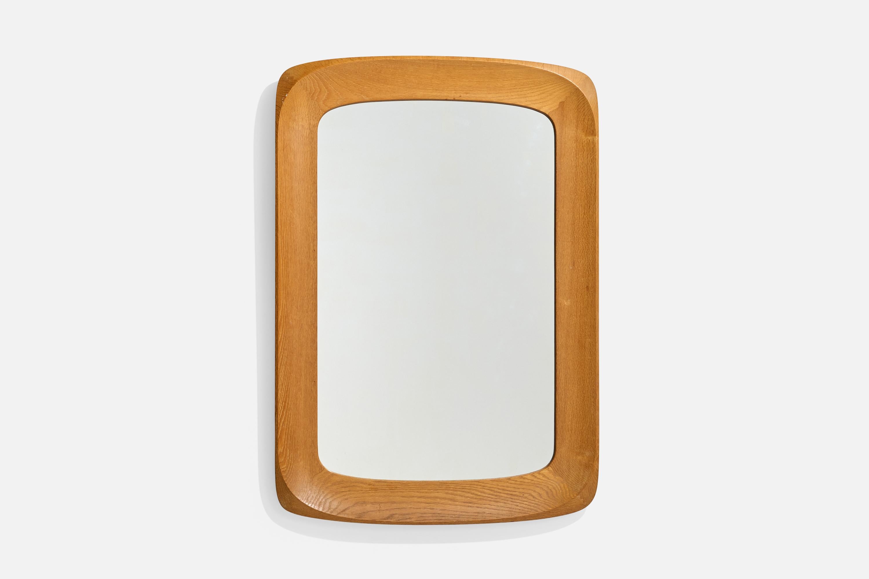 A sizable oak and crystal glass wall mirror produced by Glas & Trä, Hovmantorp, Sweden, c. 1960s.

Dimensions: 37.25” H x 25.875” W x 1.9” D