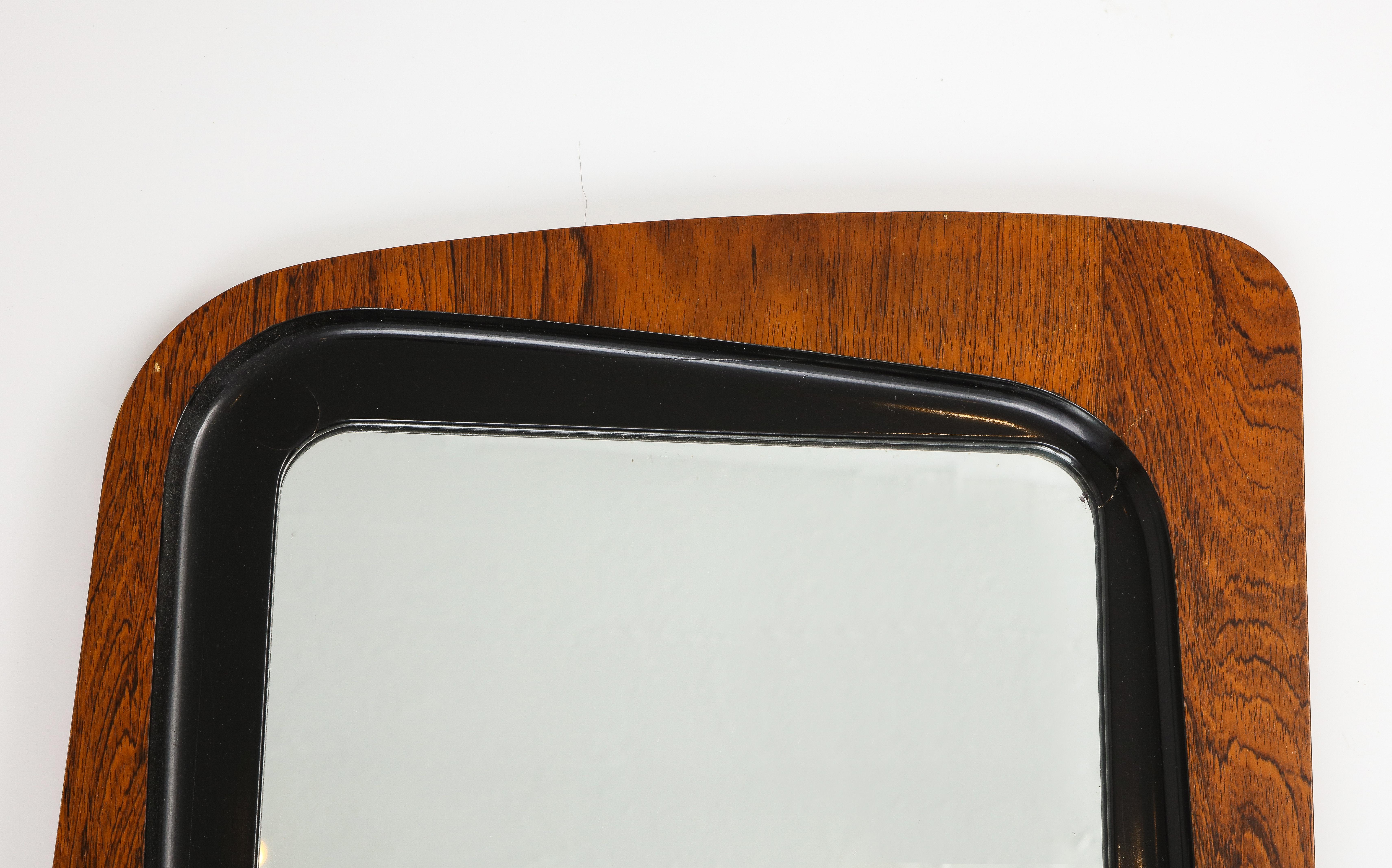 A rosewood, black-painted wood and glass wall mirror designed and produced by Glas & Trä, Hovmantorp, Sweden, 1950s. 

Some loss, requires restoration to improve condition. 