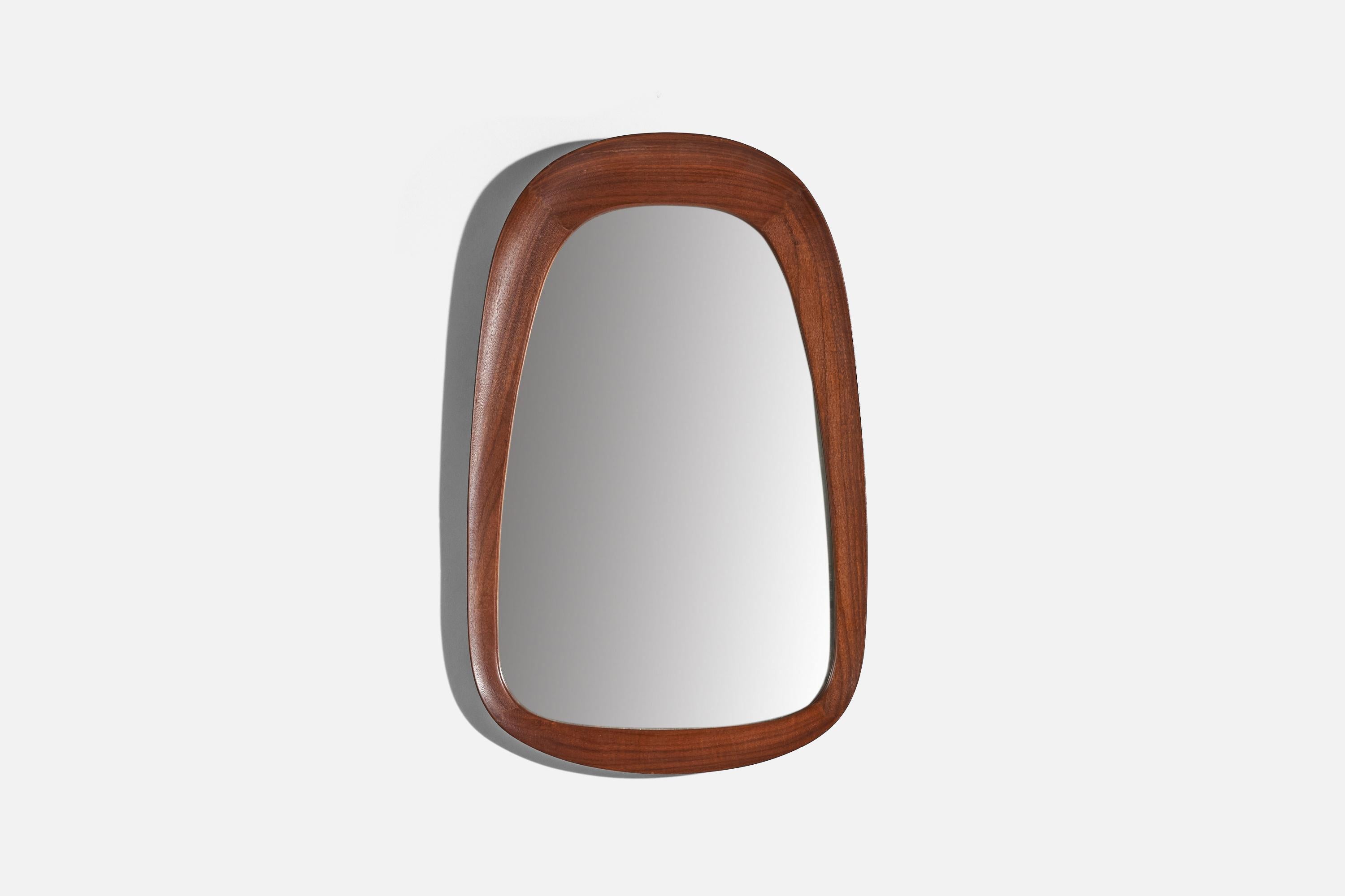 A solid teak wall mirror designed and produced Glas & Trä, Hovmantorp Sweden, 1950s-1960s.
 