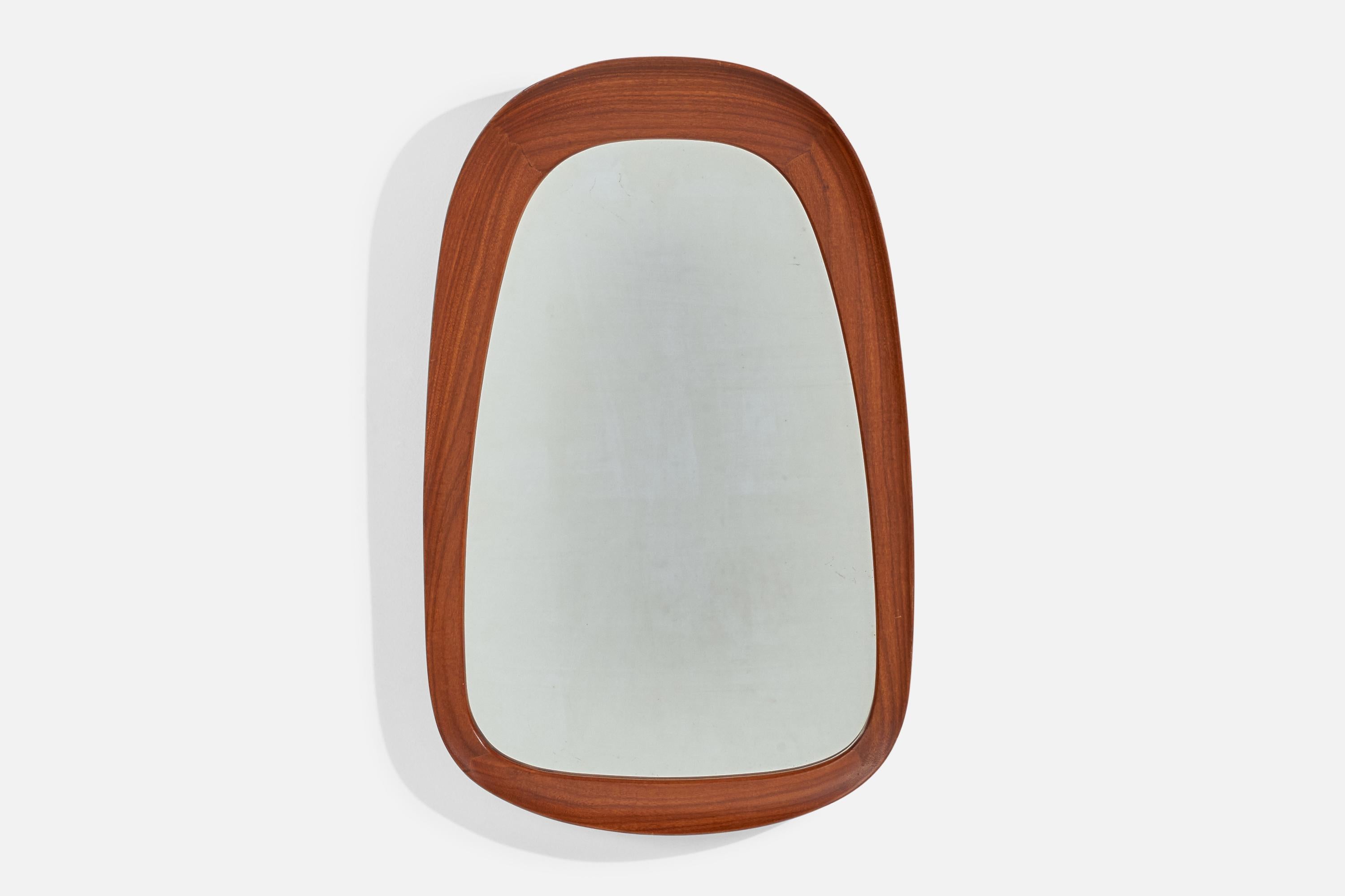 A solid teak wall mirror designed and produced Glas & Trä, Hovmantorp Sweden, 1950s-1960s.
 