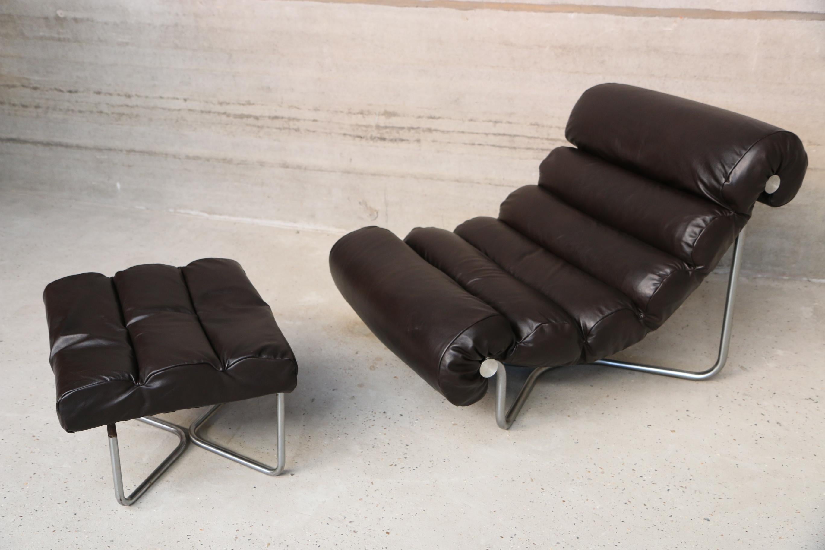 Lounge fauteuil and ottoman re-upholstered in black/brown leather. Floating segmented cushions are held by a chromed cross-shaped frame. Very comfortable and in very good condition.
Fauteuil = W 78, D 107, H 76, SH 34
Ottoman= W 56, D 52, SH
