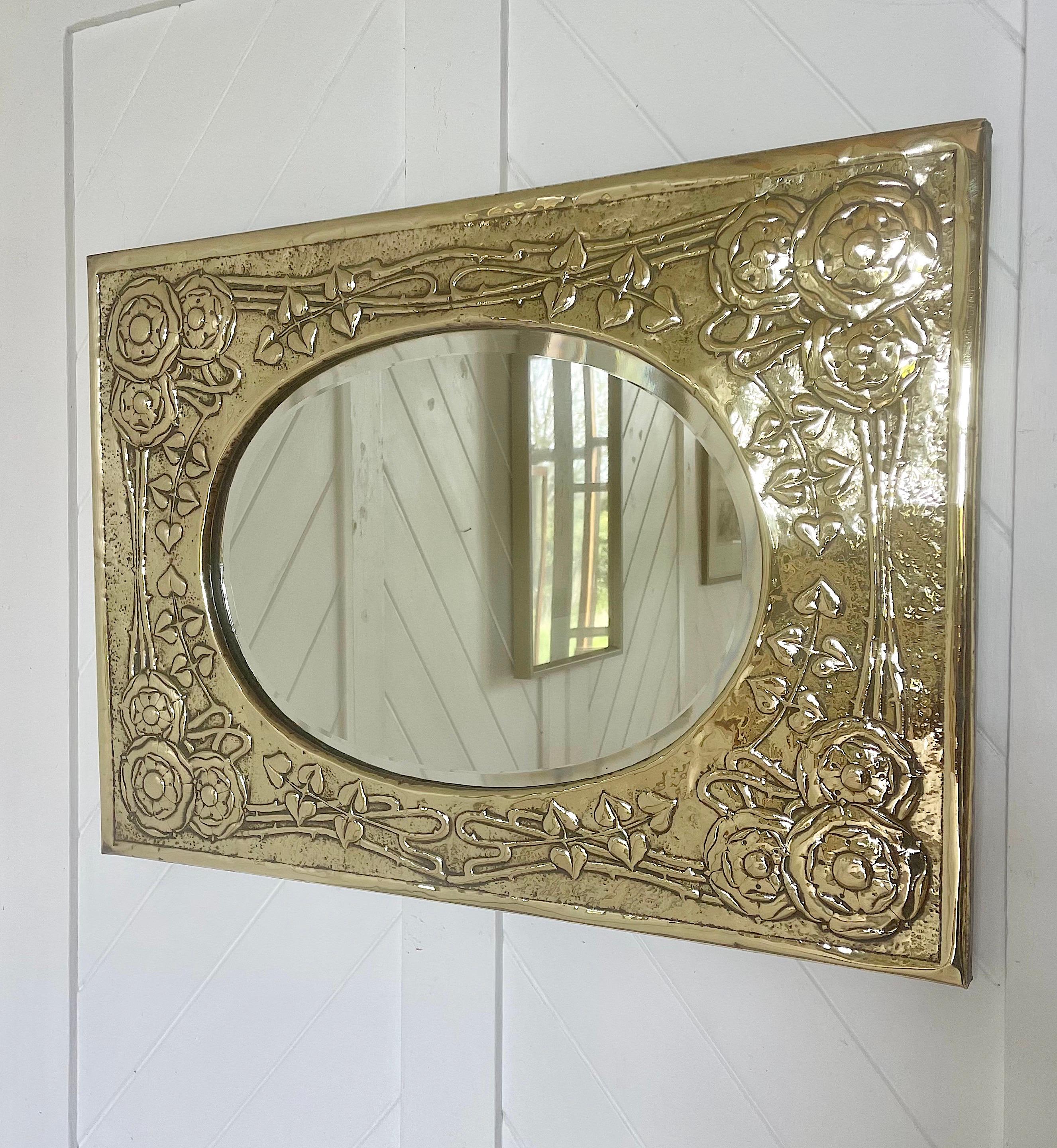 A beautiful GLASGOW SCHOOL Arts and Crafts Movement brass framed mirror by Marion Henderson Wilson, depicting intwined roses around a bevelled oval mirror.
Considered one of the “Glasgow Girls”, Marion Henderson Wilson attended the Glasgow School of