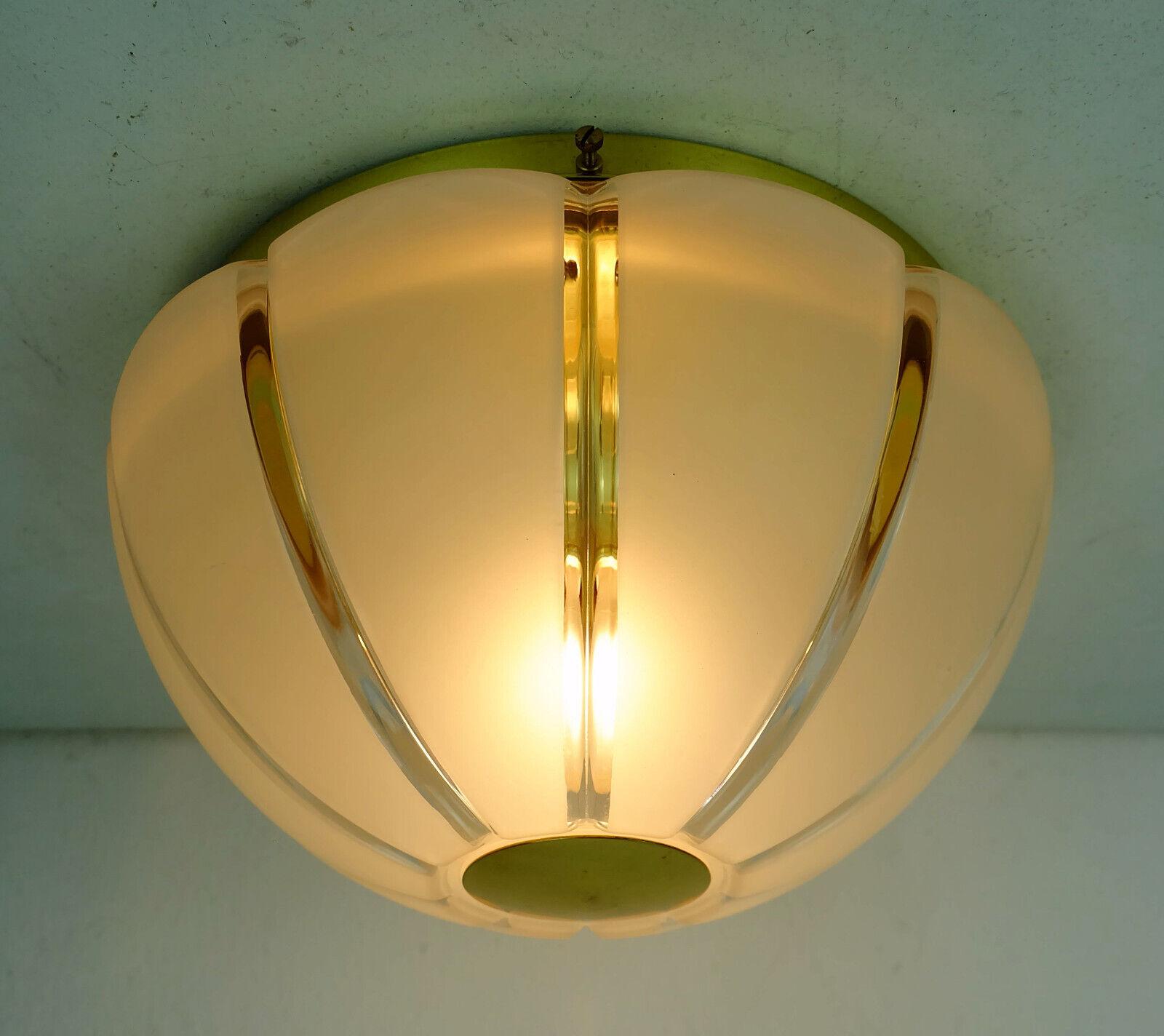 Midcentury ceiling lamp manufactured in the 1970s by Glashuette Limburg. Model A507. The shade is made of fluted clear glass that is etched on the raised parts and clear in the flutes. The translucent gold color of the base plate creates beautiful