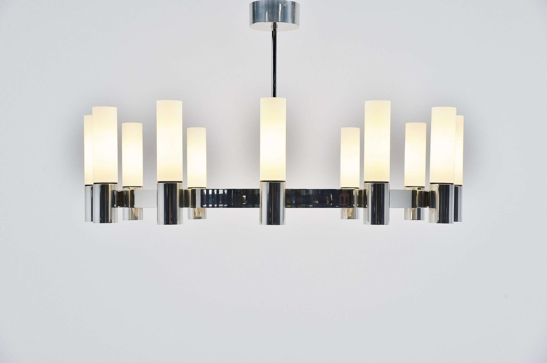 Stunning extra large chandelier designed and manufactured by Glashütte Limburg, Holland, 1970. This lamp is made of a chrome plated metal frame and has white milk glass tubular shades. This amazing large lamp has a fantastic minimalistic shape and