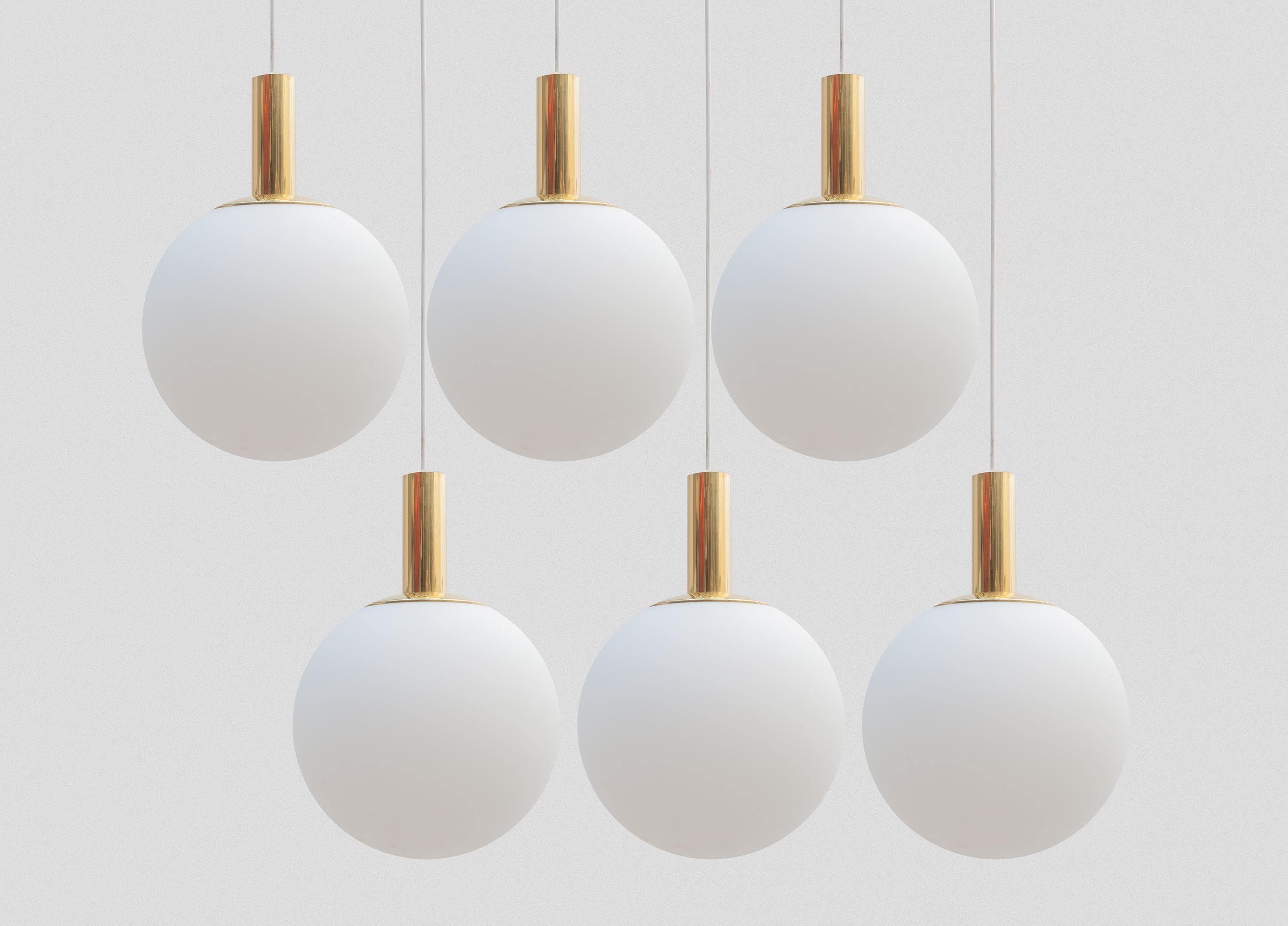 Set of six globe pendant lamps. Classic opal milk glass orb shade with gold tone hardware in a very good condition. Designed by the famous manufacture Limburg Glashütte, Germany.
   