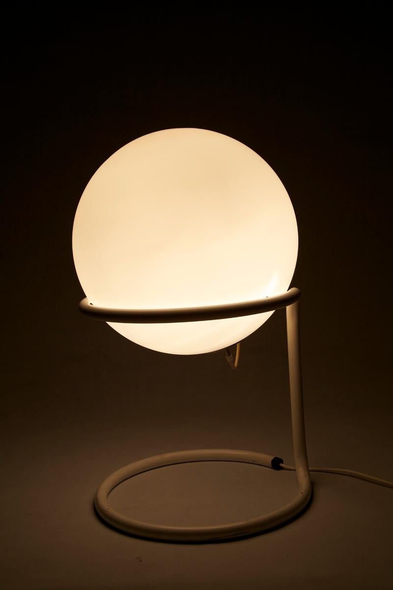 Table or floor lamp, manufactured by Glashütte Limburg, Germany, 1970s. This lamp is built of a spherical light resting on a white lacquered metal structure. 

  