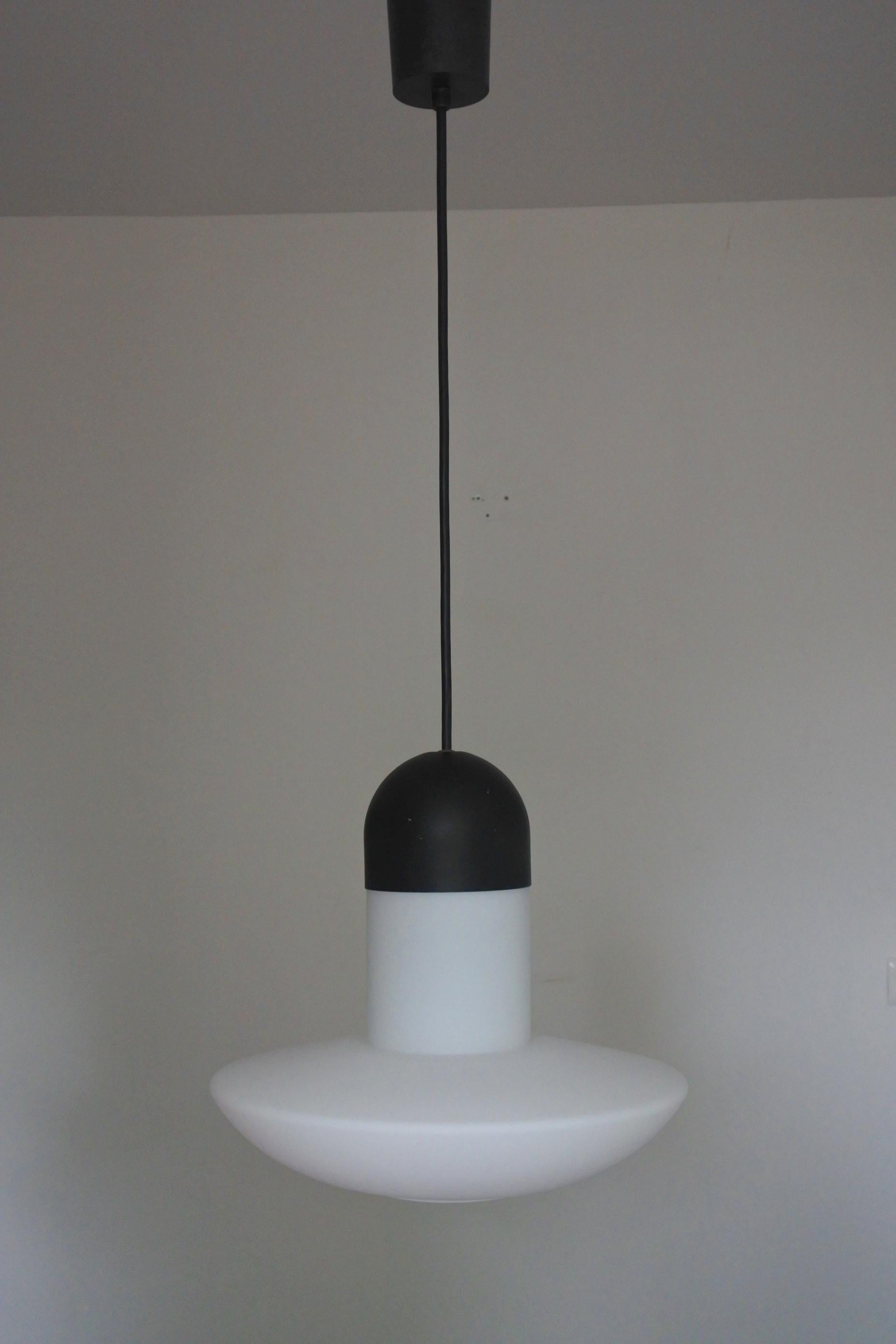 Pendant lamp by German lamp manufacturer Glashütte Limburg.
Black lacquered metal and white opal glass.
3 available.
Works great as a group. Ideal for large spaces and high ceilings.
Adjustable height, as shown 120 cm, the cable can easily be