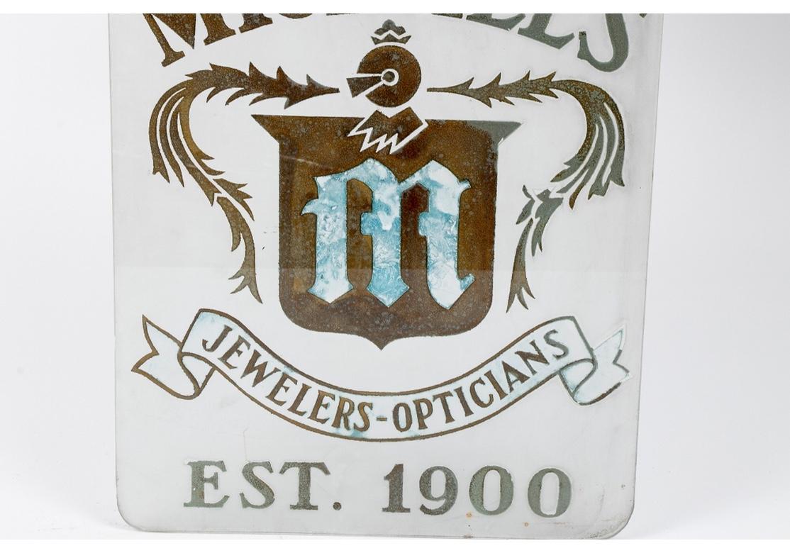 Folk Art Glass Advertising Plaque, “Michaels Jewelers And Opticians”