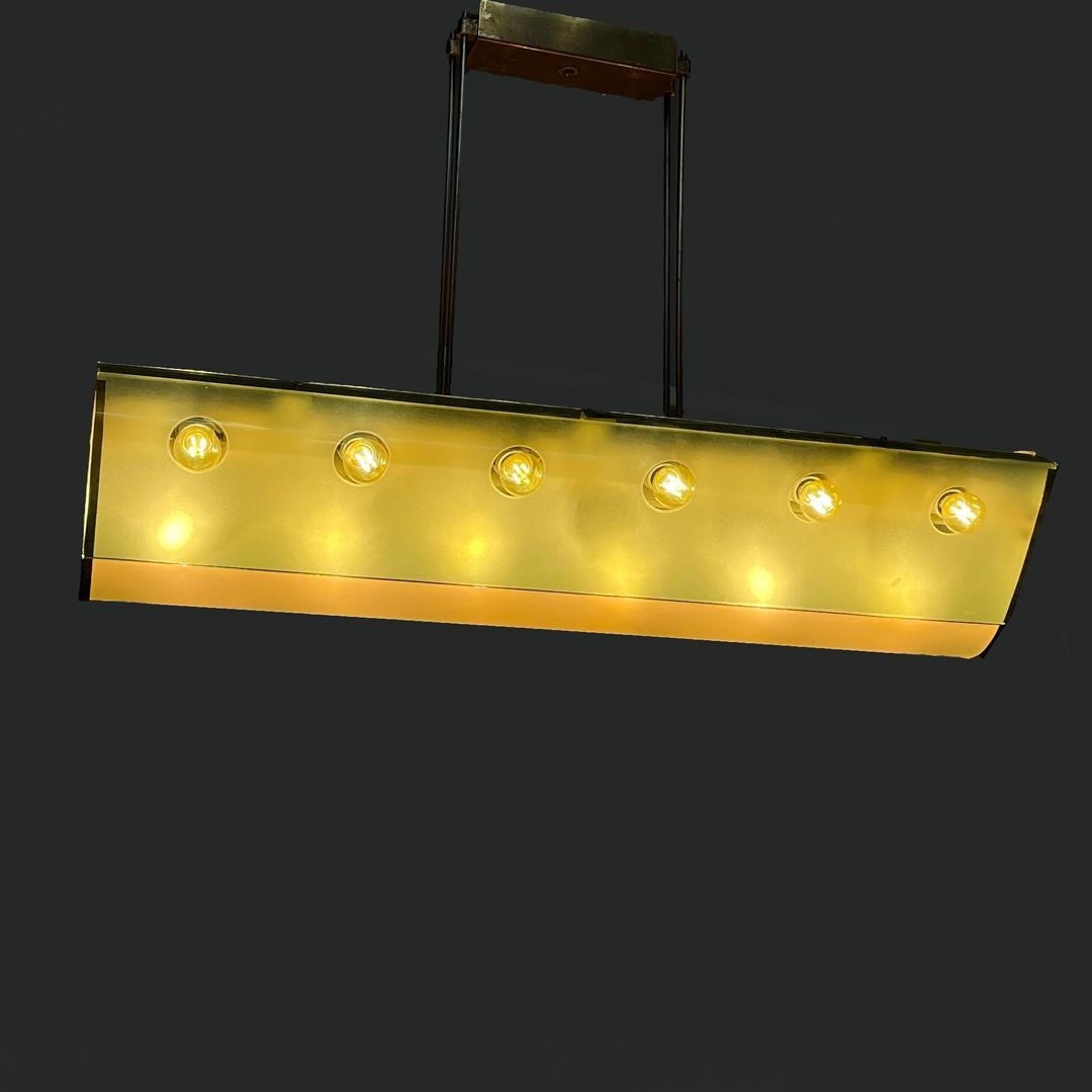 Glass and brass chandelier 2296 by Max Ingrand for Fontana Arte, 1950s
Ceiling lamp model 2296 oblong, in frosted, transparent and colored glass with brass frames composed of eighteen bulbs.
It has a long V-shaped body with a rounded base, in