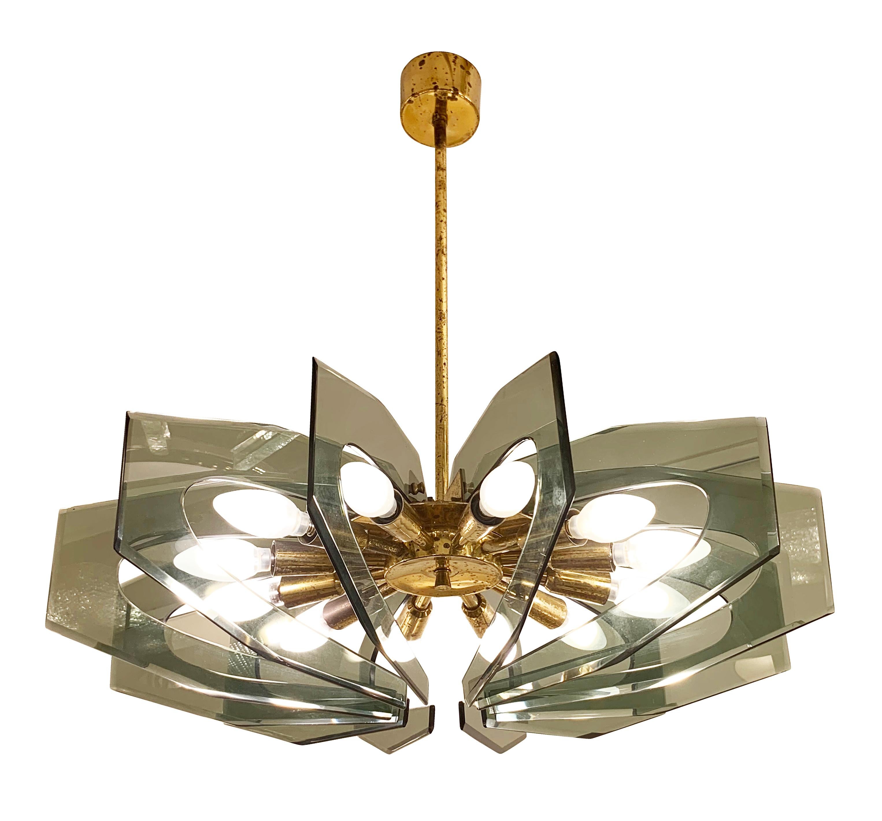 Italian Mid-Century chandelier by Paroldo with green smoked glasses on a brass frame. Each glass piece is meticulously cut and beveled. Holds twelve candelabra sockets. Height of stem can be adjusted.

Condition: Excellent vintage condition, minor