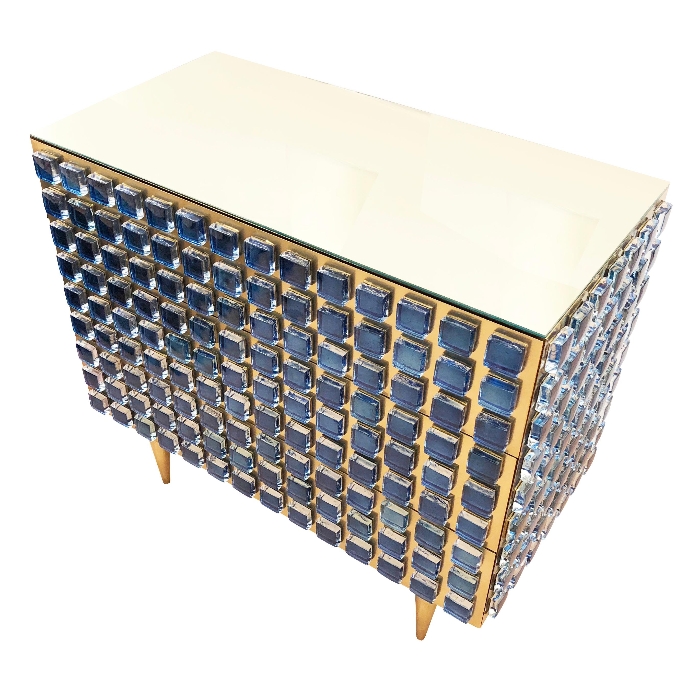 Interno 43 chest of drawers or cabinet made for Gaspare Asaro’s studio line, formA. Each piece is handmade in Italy and composed of brass paneling, dozens of colored glass medallions and a clear glass top. The model shown is a chest with three