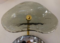 Espejo contemporáneo de cristal y latón, creación belga de Jacques Nonnon