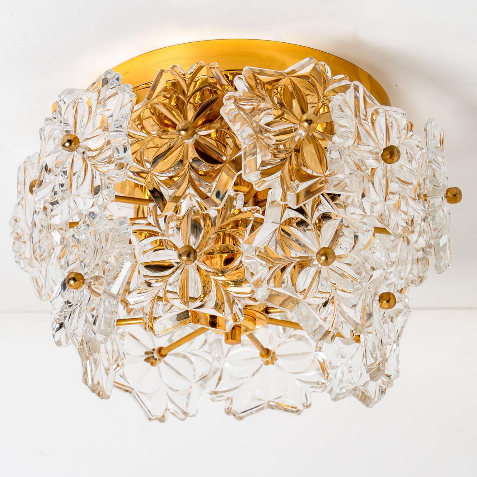 This sculptural flush mount has the design of a bouquet of textured glass flowers and are from the historical lighting company From Germany, manufactured Mid-century, circa 1970 (late 1960s or early 1970s).

The fixture has several flower shaped
