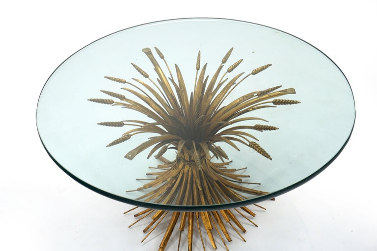 Glass top cocktail table with bundled wheat base of brass made in Italy, 1960s. Purchased by the original owner while traveling Europe 50 years ago. The base is made of gold gilded metal and solid brass. It has a wonderful patinal from age. The