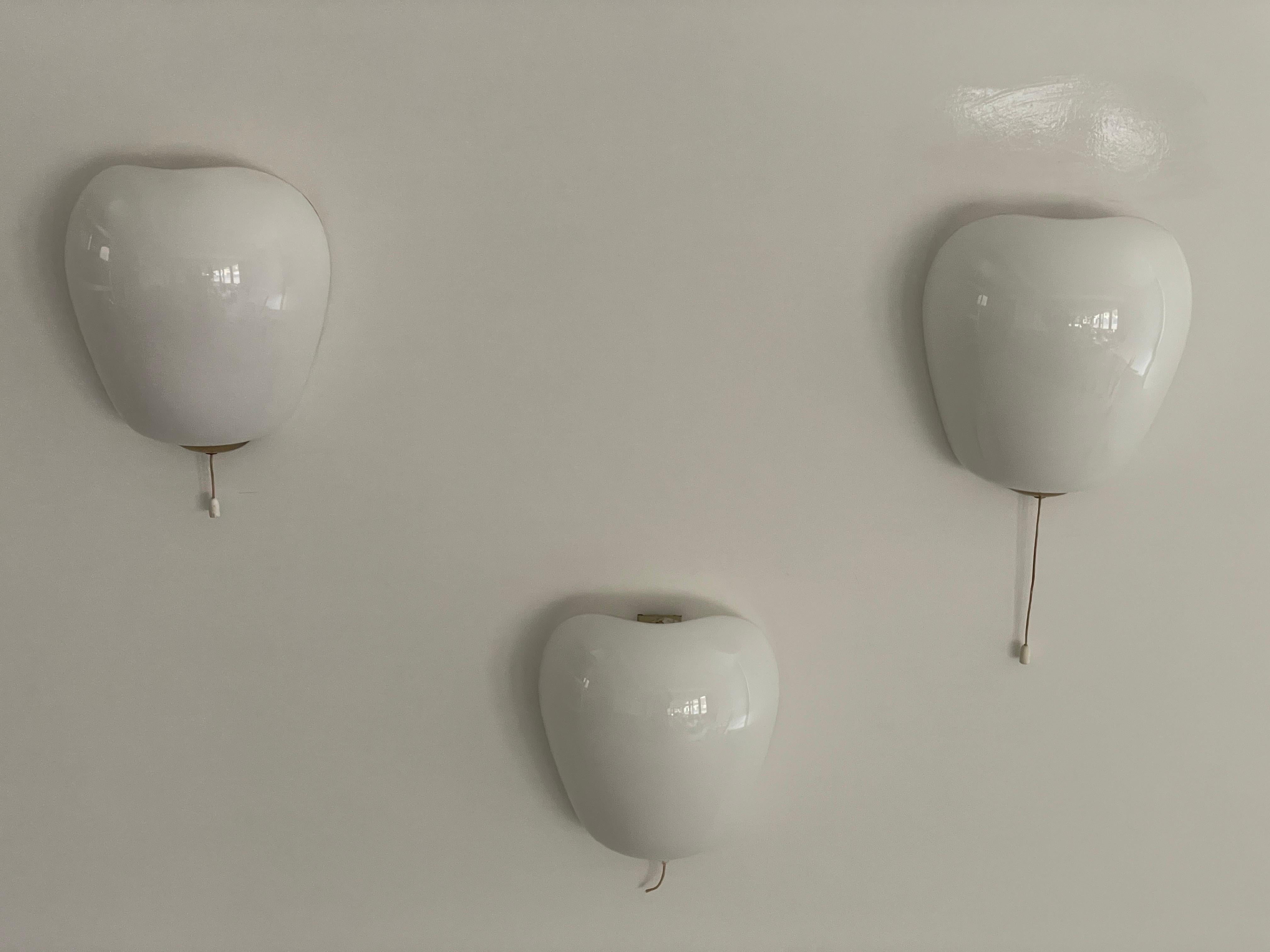 Glass and Brass Sconces by Wilhelm Wagenfeld for Peill & Putzler, 1960s, Germany
set of 3

Very elegant and Minimalist wall lamps

Lamps are in very good condition.

These lamps works with E14 standard light bulbs. Each lamp works with 1 light bulb.
