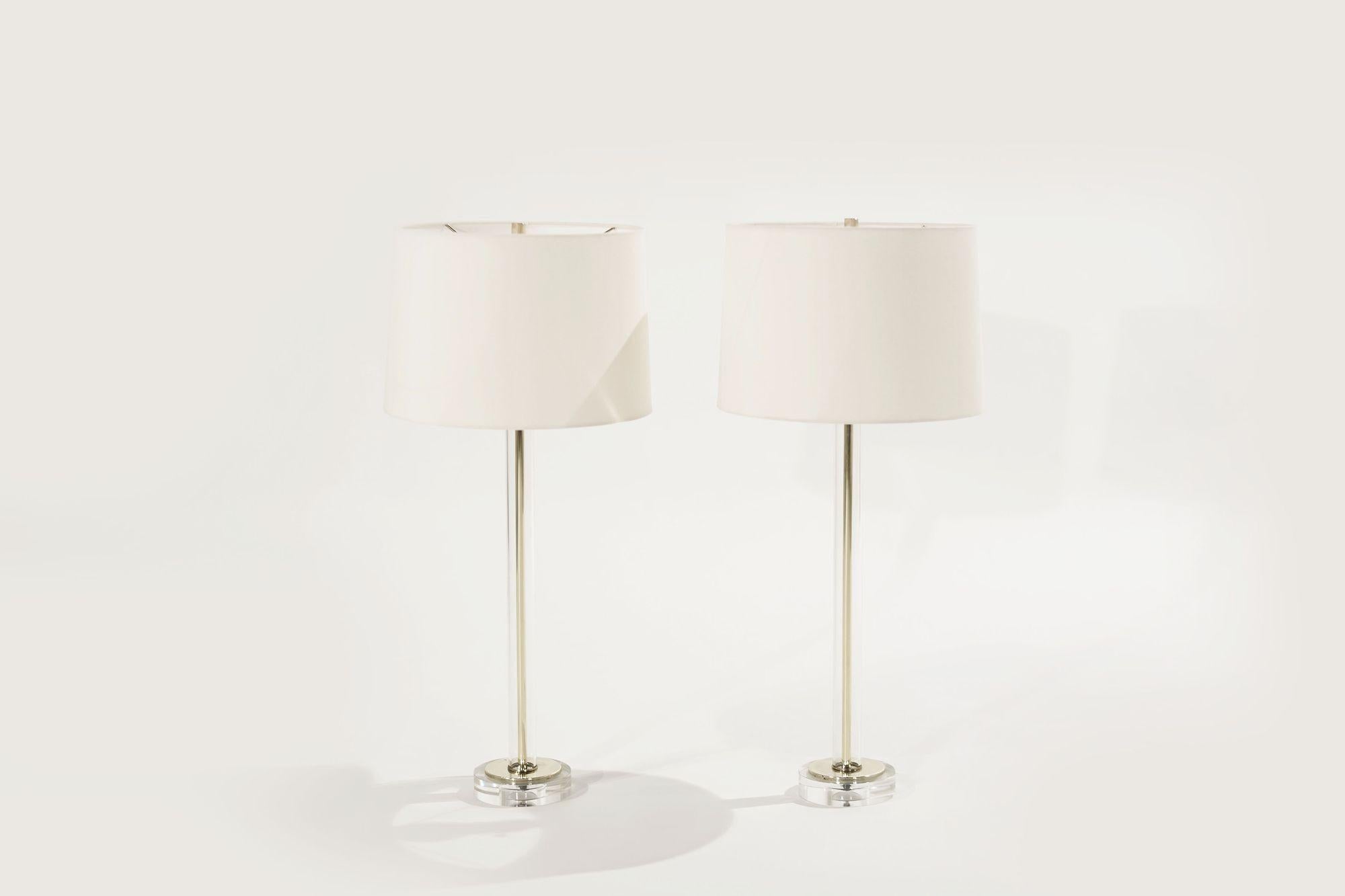 A gorgeous set of table lamps in the style of Charles Hollis-Jones, featuring a tubular glass stem, brass, and lucite stands. Circa 1960-1969. Completely rewired, new linen shades
 
Other designers from this period include Paul McCobb, Karl