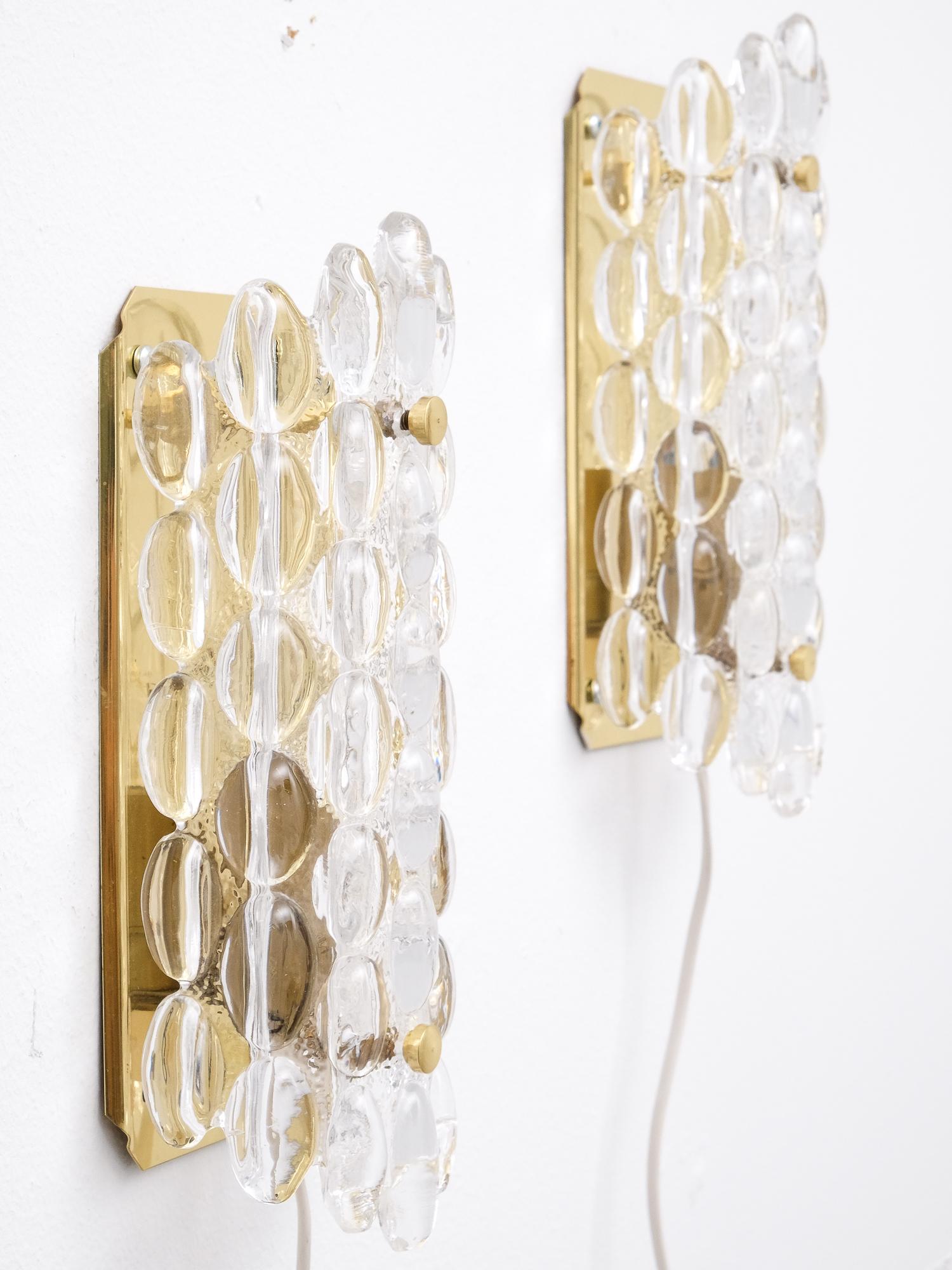 A pair of wall sconces with large glass bubbles mounted on a brass frame by Carl Fagerlund for Orrefors, Swedish, circa 1960s.

Single E14 bulb holder in each sconce.