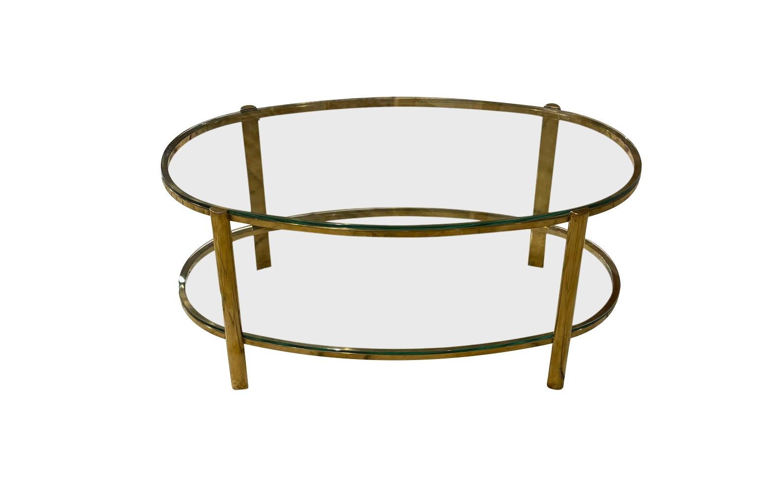 1940's French Jacques Quinet for Malabert unusual oval shaped coffee table.
Two tiers.
Signature curved corners.
Polished bronze.