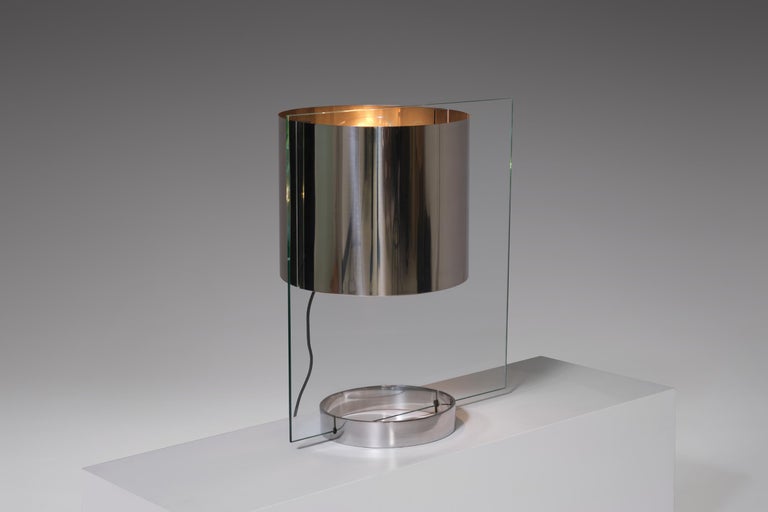 Rare table lamp by Lumenform, Italy, 1970. Extraordinary design made from a rectangular sheet of glass and stainless steel shade, base and lighting part. This sophisticated sharp lined lamp provides a very nice light, light is transported true the