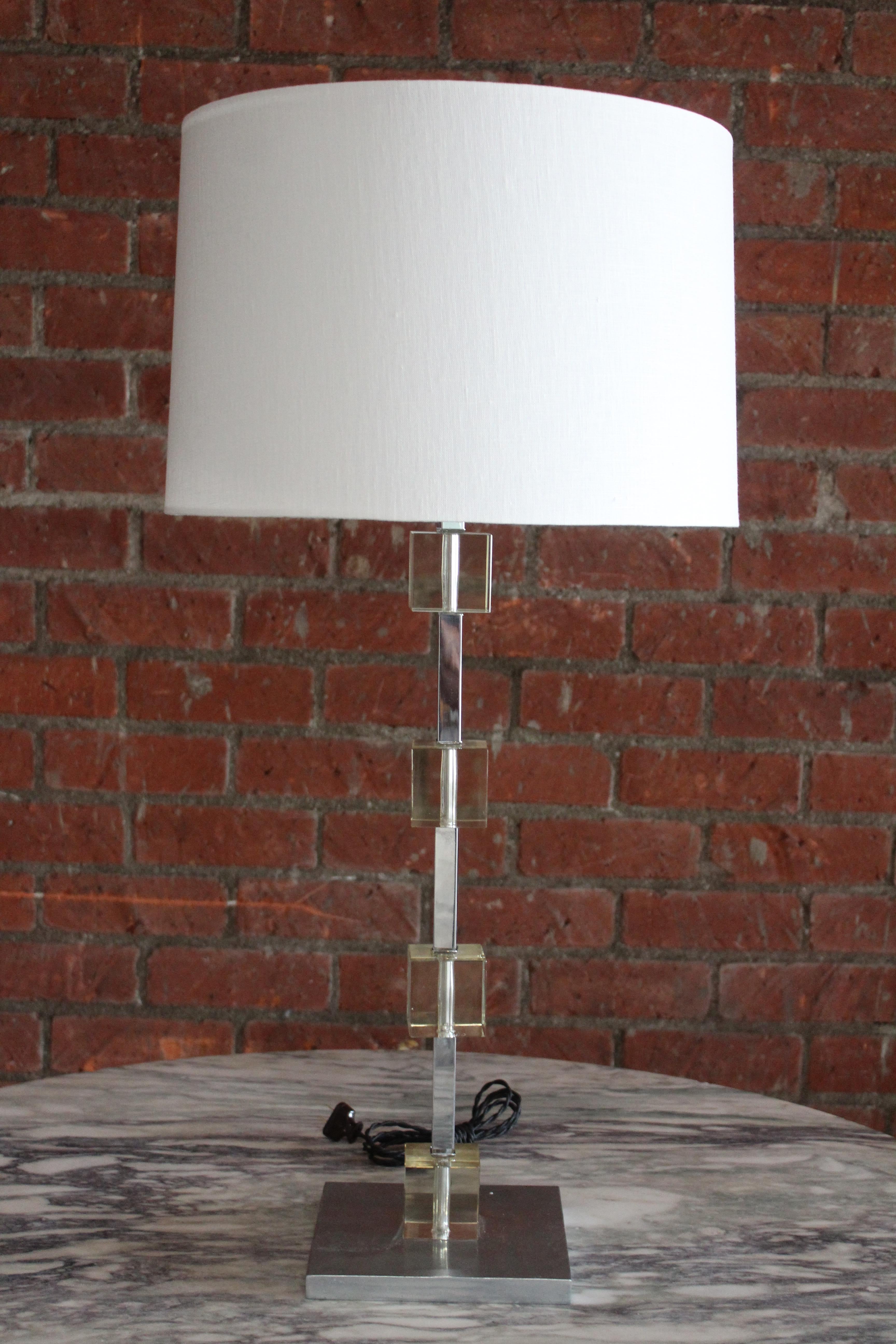 A vintage chrome and glass table lamp in the style of Jacques Adnet. Newly rewired with custom shade in Belgian linen. Measures: 36.5