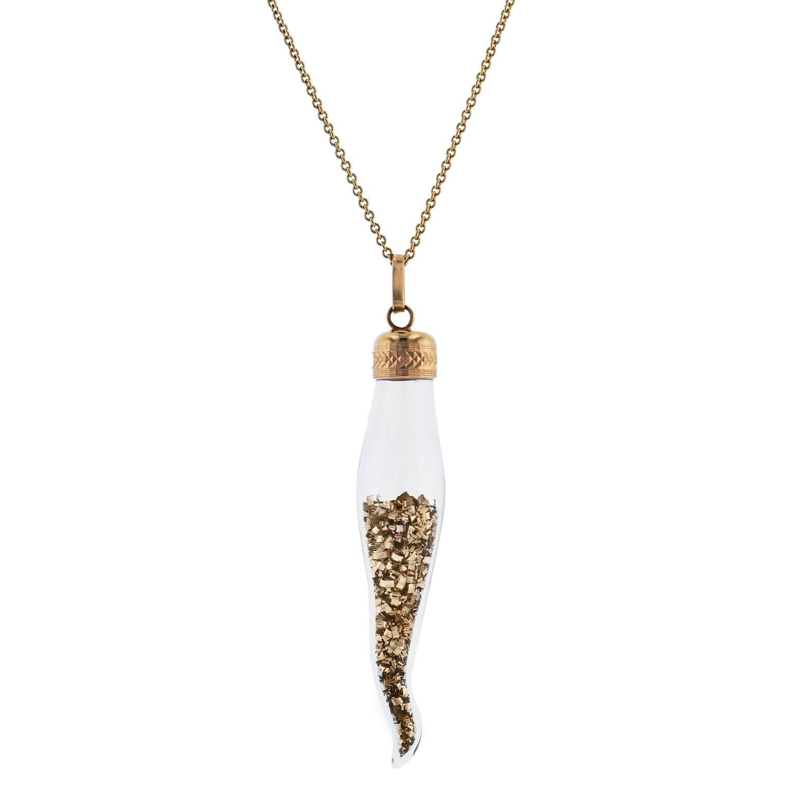 This previously loved, very rare 1970’s Italian horn pendant is understated yet bold. Fashioned in glass and filled with 14 karat yellow gold shavings, this Italian horn is not an everyday find. Featuring 14 karat yellow gold embellishments, embrace