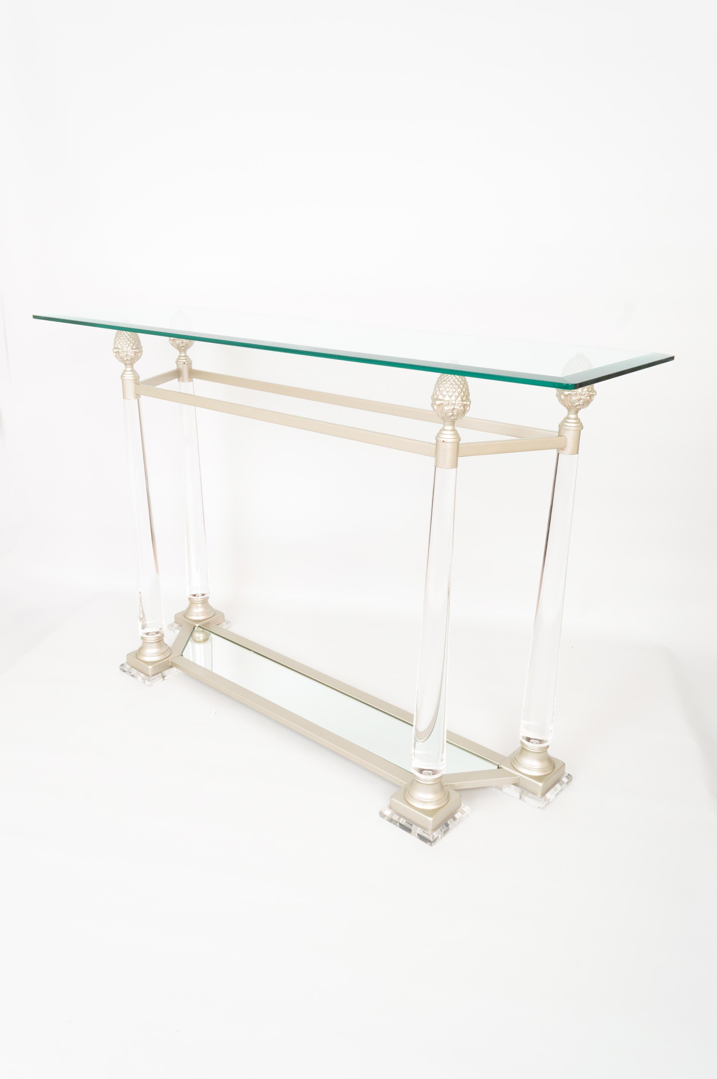 A glass and lucite console table France C.1970
Tapered lucite supports, pineapple detailing and a mirrored base.
In excellent vintage condition commensurate of age.