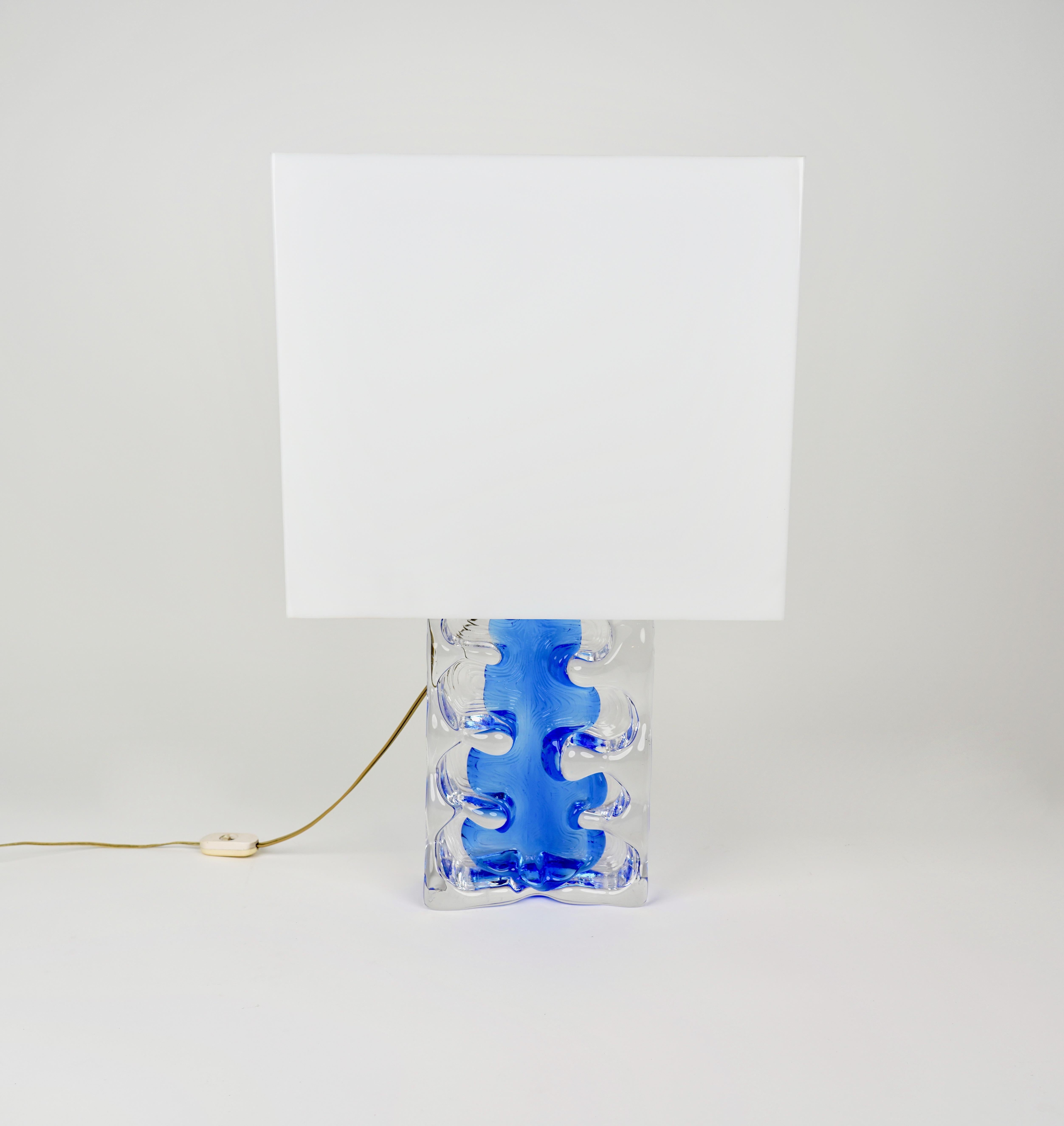 Beautiful table lamp in transparent and blue art glass with a unique lampshade in lucite. 

The original sign is engraved on the back, as visible in the pictures.

Made in France in 1970s.