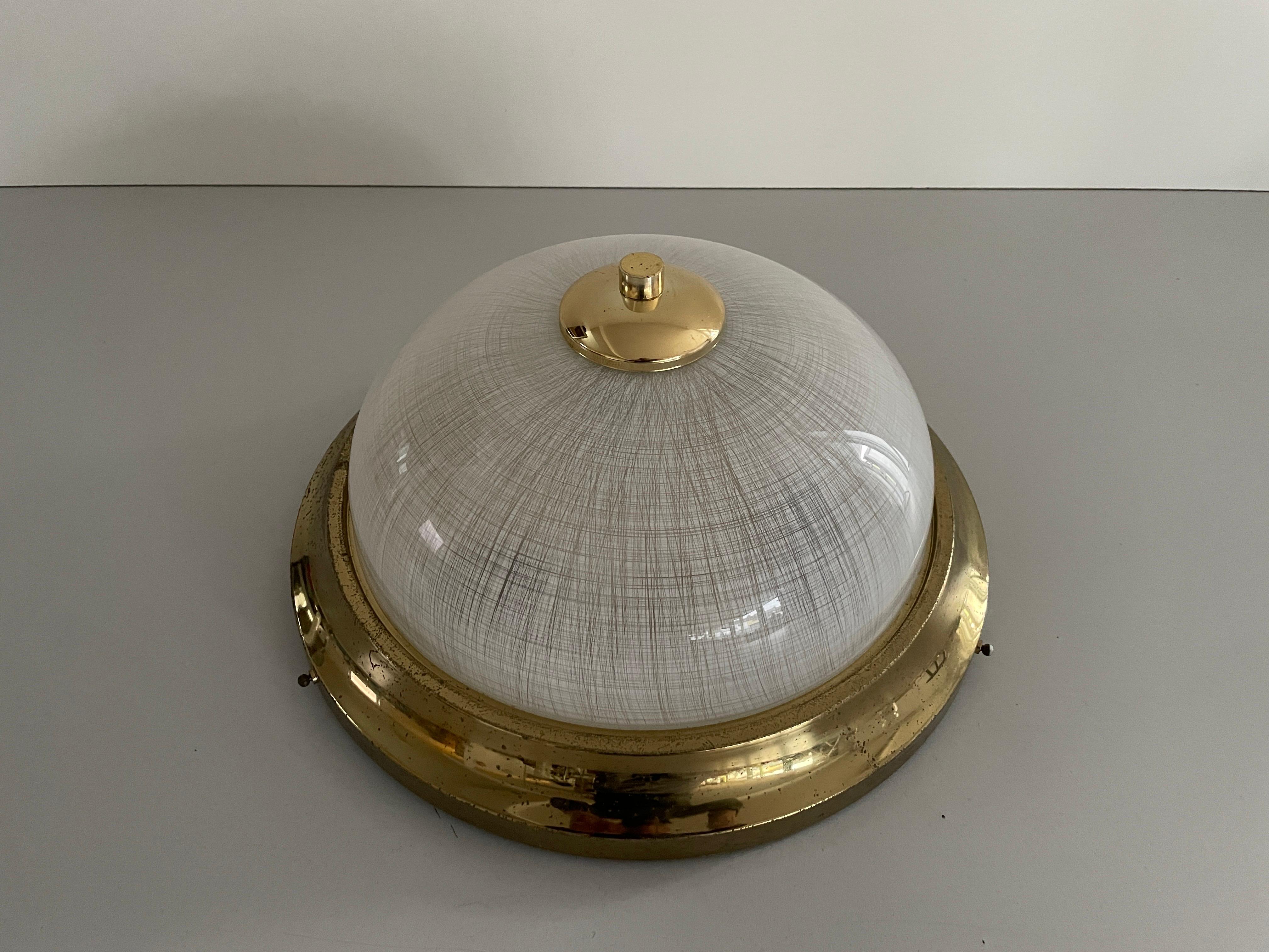 Glass and Messing Ceiling Lamp Flush Mount, 1960s, Italy

Lampshade is in very good vintage condition.

This lamp works with 2x E14  light bulbs. 
Wired and suitable to use with 220V and 110V for all countries.

Measurements:
Diameter: 37 cm
Height: