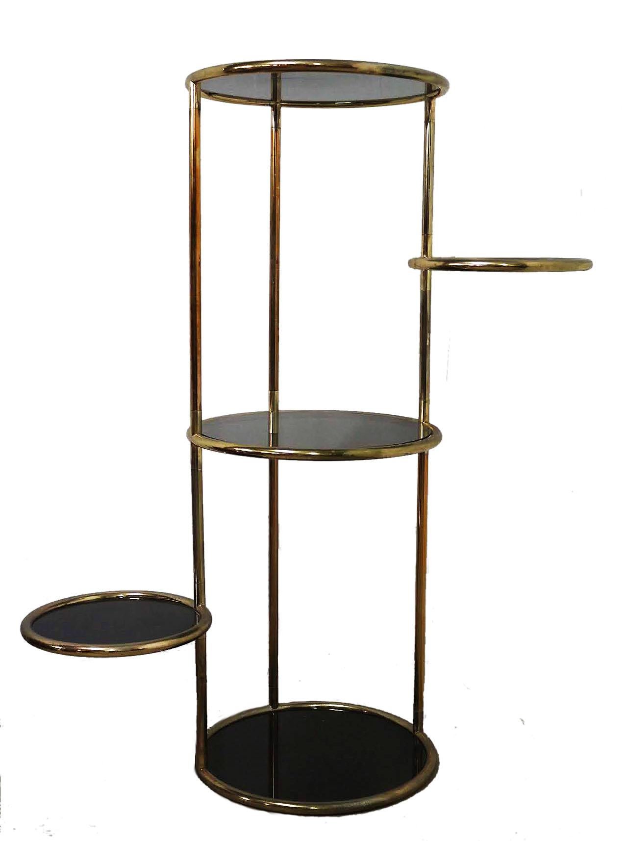 Midcentury versatile display unit five-tier articulating table, circa 1970
Étagère
Smoked glass and gilt chrome
Solid and sturdy
Very good quality
Two shelves swivel out 360 degrees each 40 cms in diameter
Three glass shelves are fixed
Very