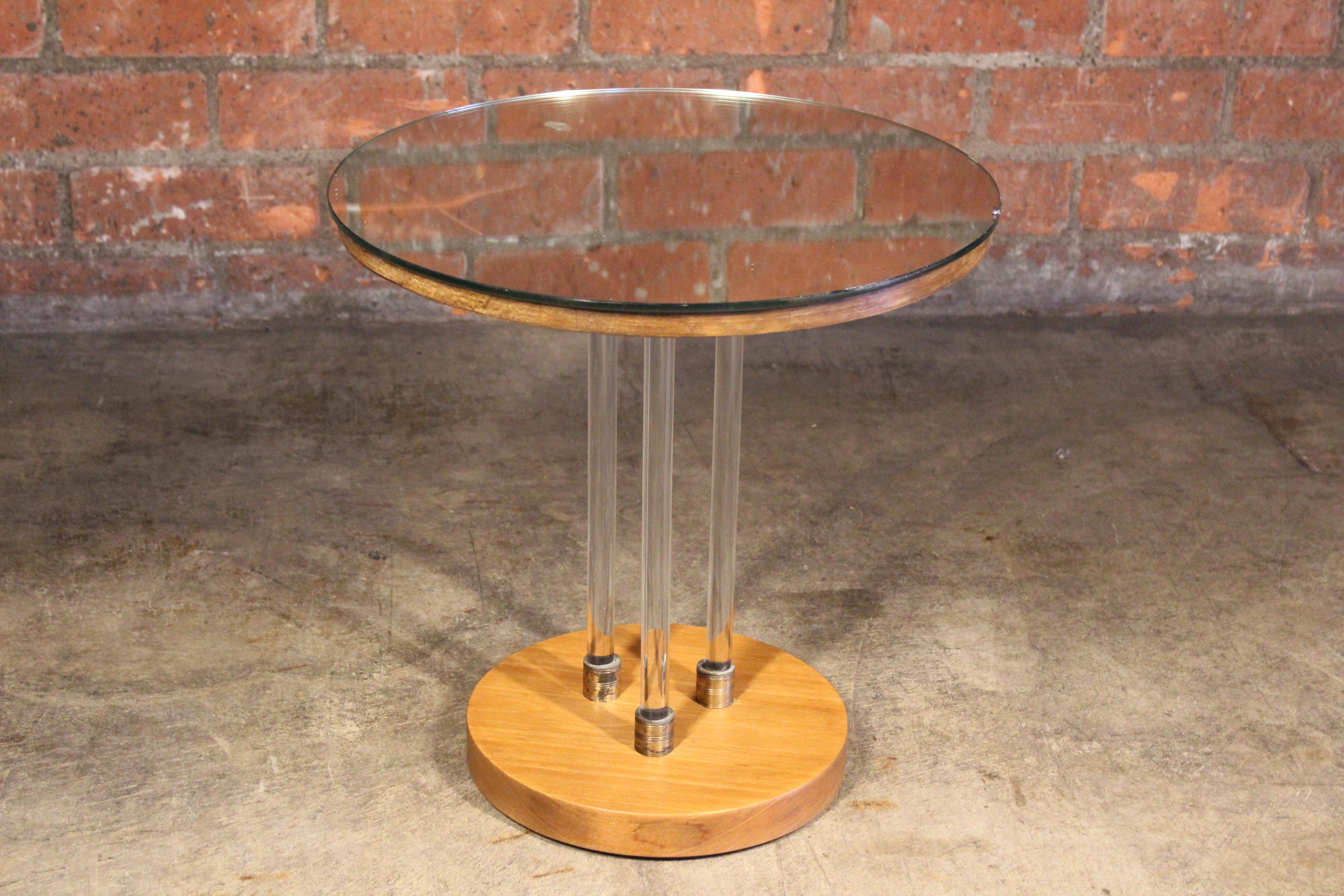 A unique side table with a three-column glass base and mirrored top. Features a solid wood base with brass accents. The wood base has been refinished. Glass top is original to the table and shows minor signs of wear.