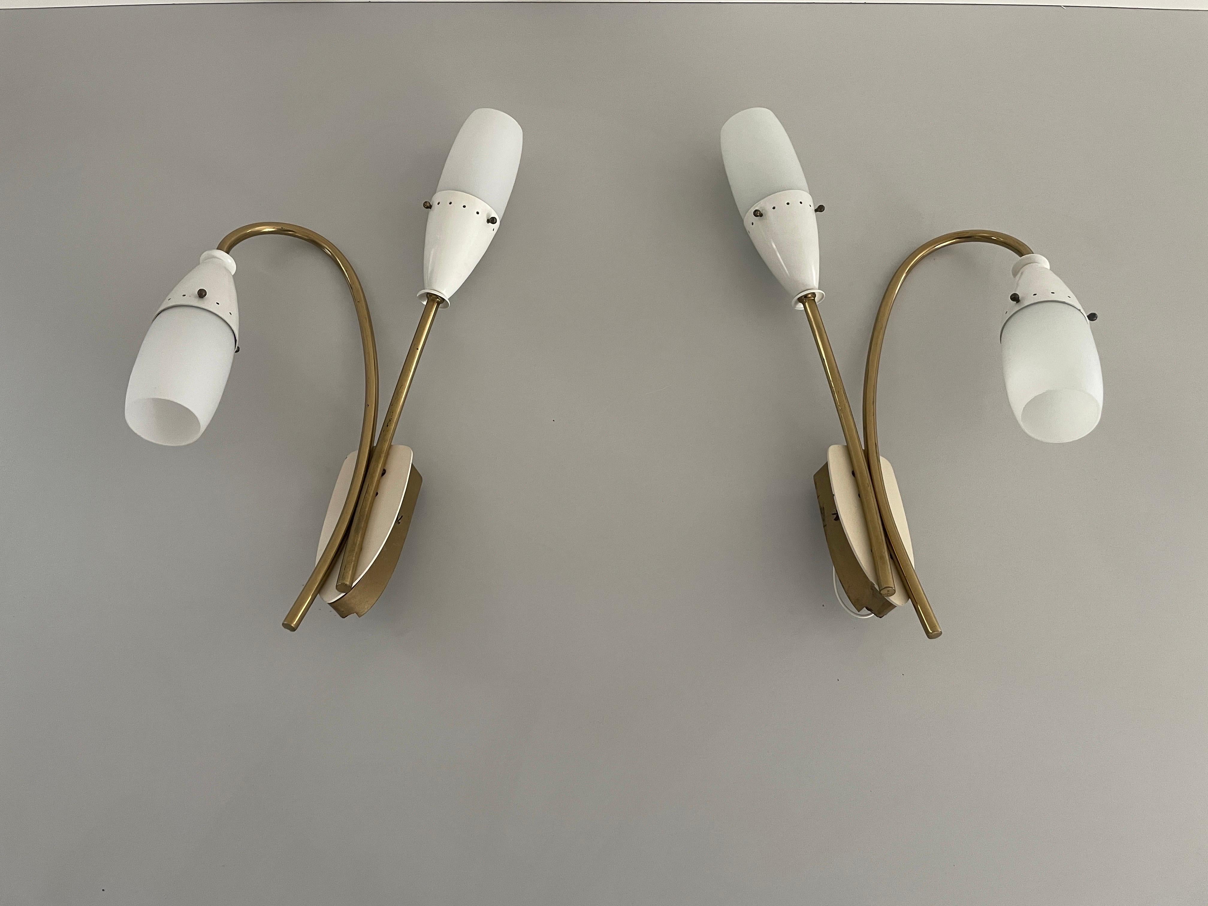 Glass and White Metal Twin Head Sputnik Pair of Sconces, 1950s, Italy

Very elegant and Minimalist wall lamps.

Lamps are in excellent condition.

These lamps works with E14 standard light bulbs. 
Wired and suitable to use in all countries. (110-220