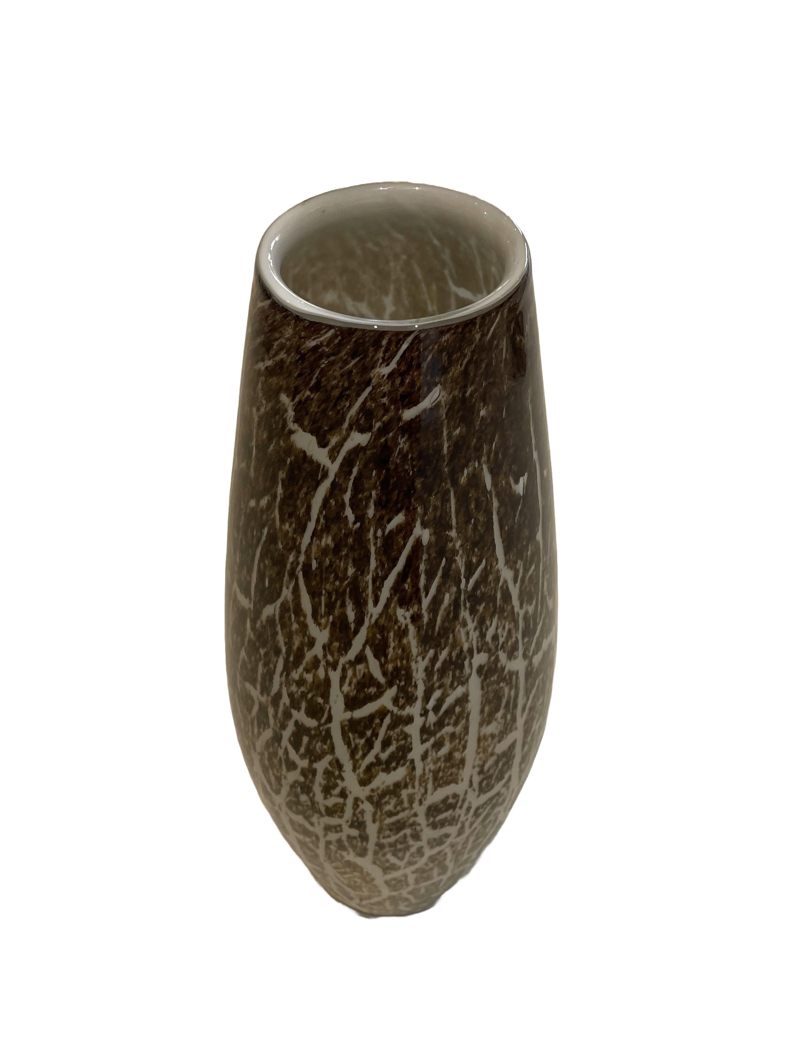 Add a touch of nature-inspired chic to your home decor with this large 19.5” inch tall vase! The dark brown base color and white animal print pattern adds organic modern charm to any space.
The perfect addition to any room looking for a bit of