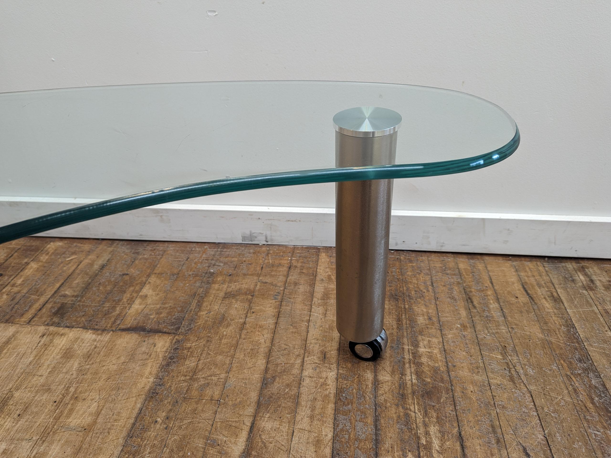 Glass Biomorphic Coffee table on casters  In Good Condition For Sale In New York, NY